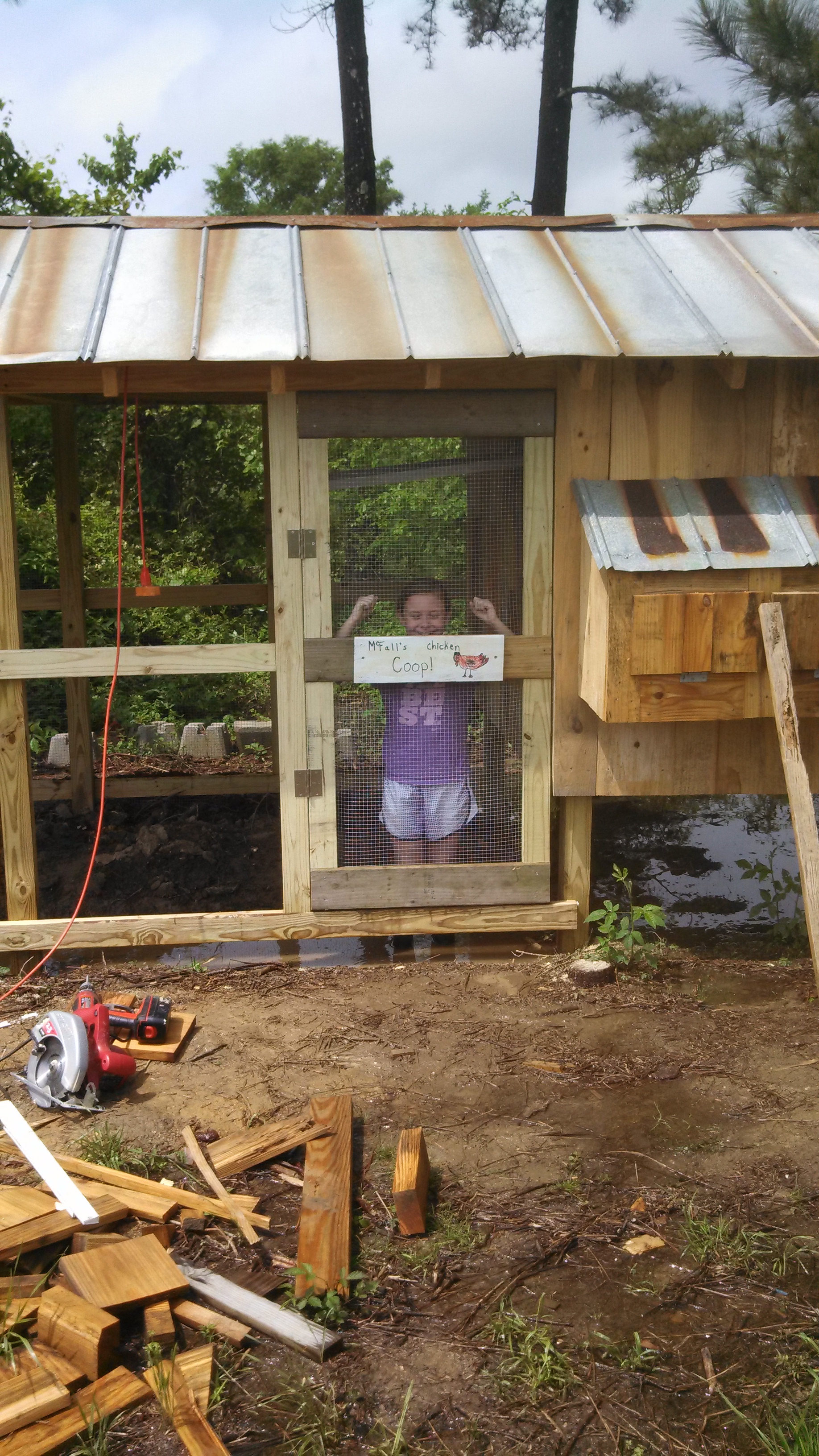 Built and installed the run door.  Notice the water standing under the coop and in the run.  That will be addressed when we get the run finished.  We had just received 6 inches of rain in less than 12 hours.