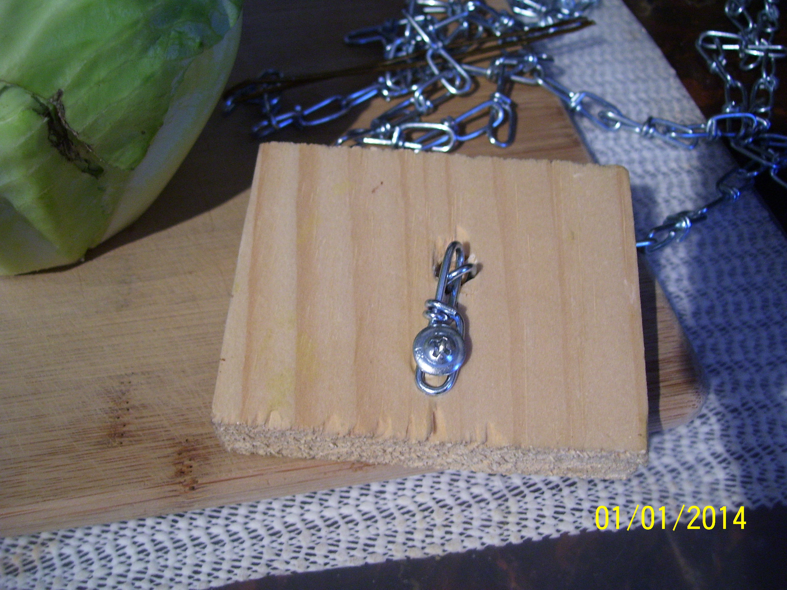 Cabbage "piñata" for decreasing bordom, increasing greens. Drill hole in small piece of wood, run chain through it, screw it down.