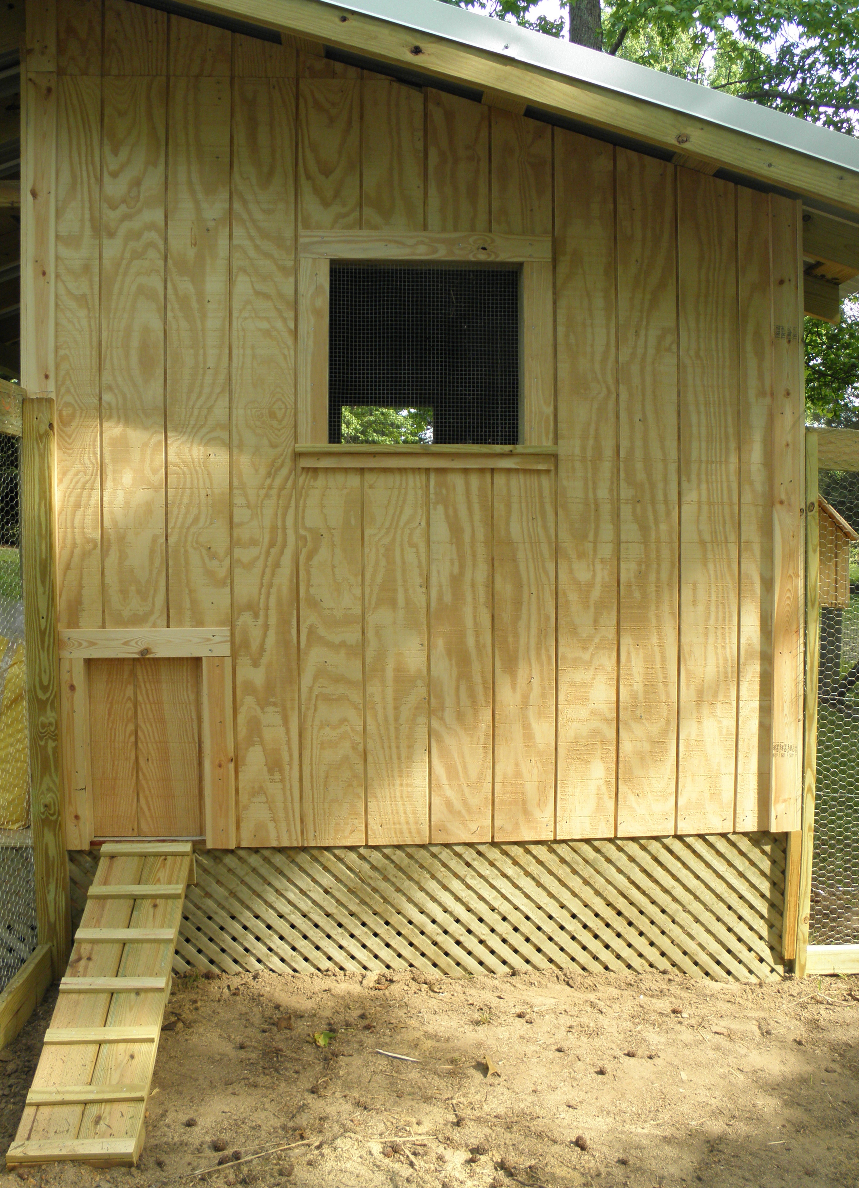 Chicken door closed. Lattice placed under the coop to enclose the run.