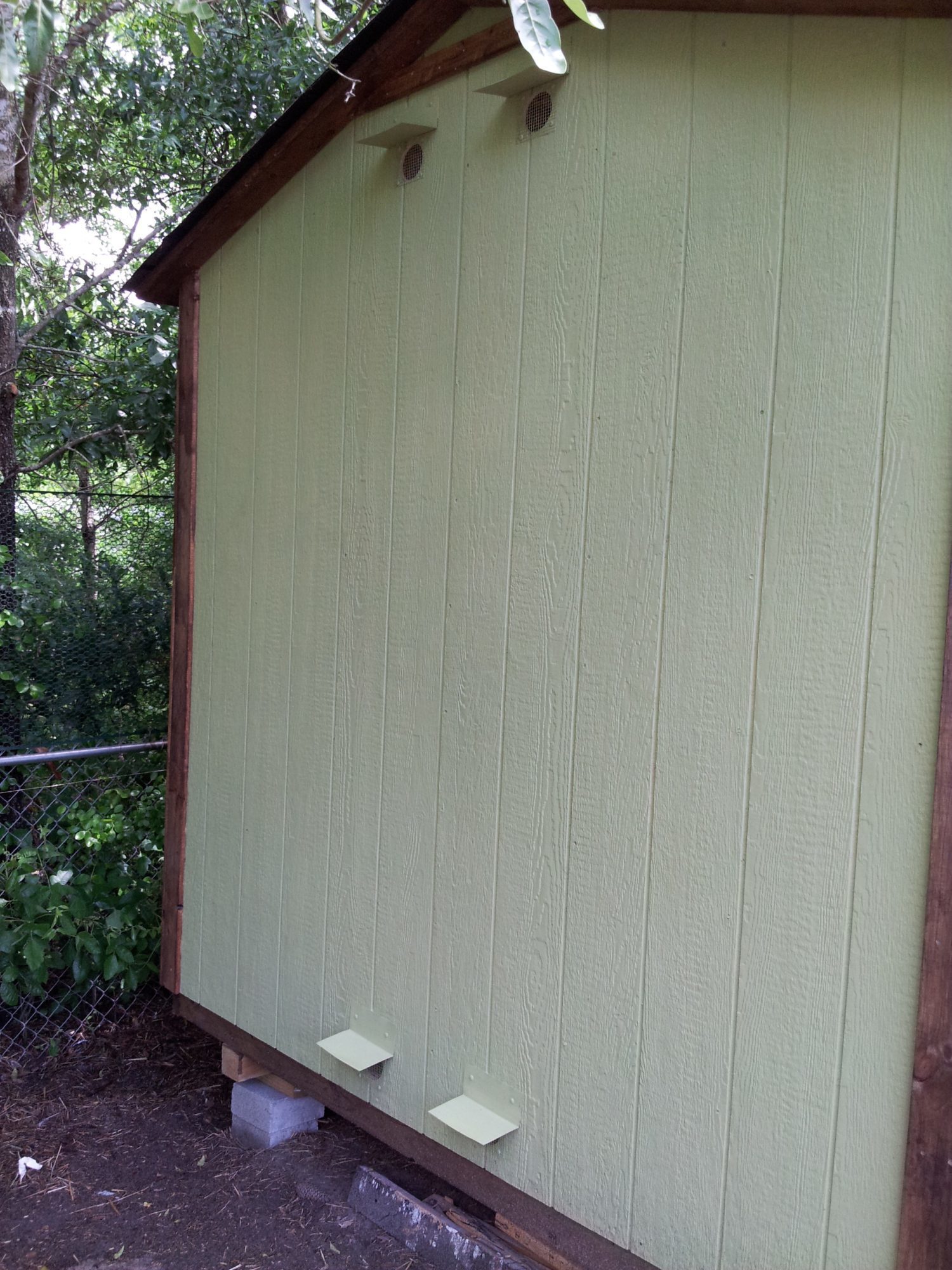 Circular vents cut out, with covers installed and wire cloth over the holes