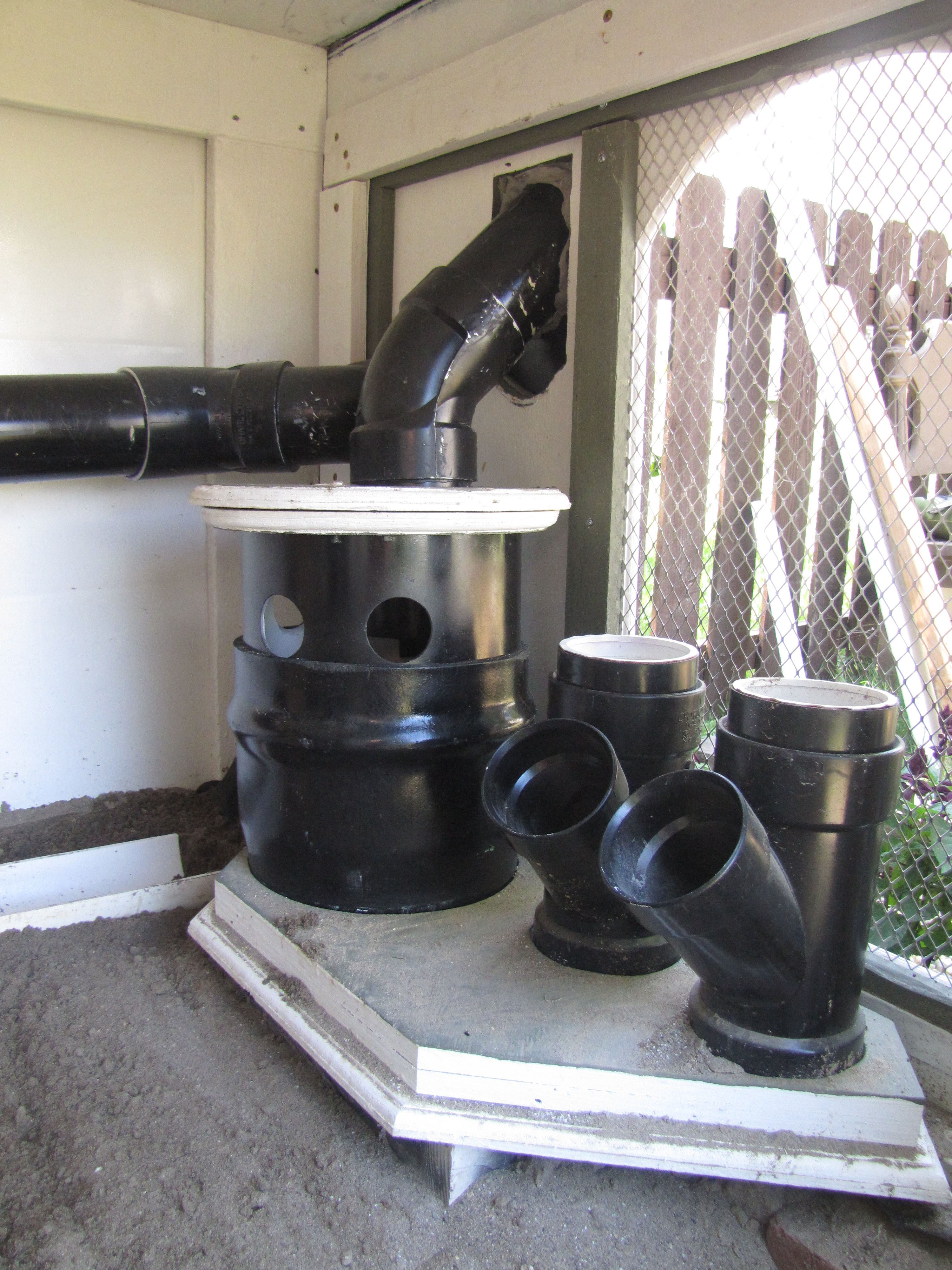 Close up of feed and water system, smaller feeders are for oyster shell and grit