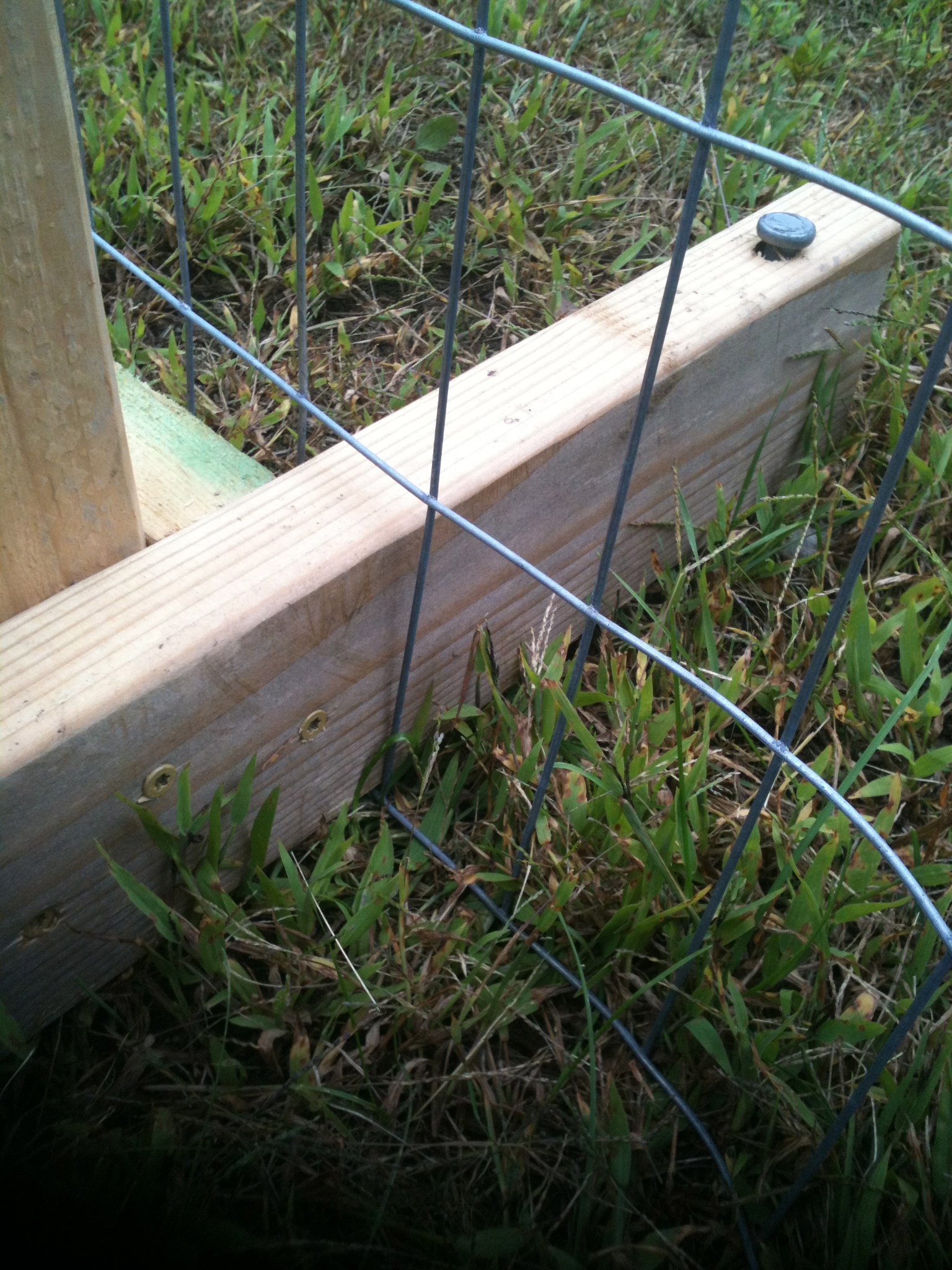 close up of portable paddock post braces, through the fencing, with spikes driven in
