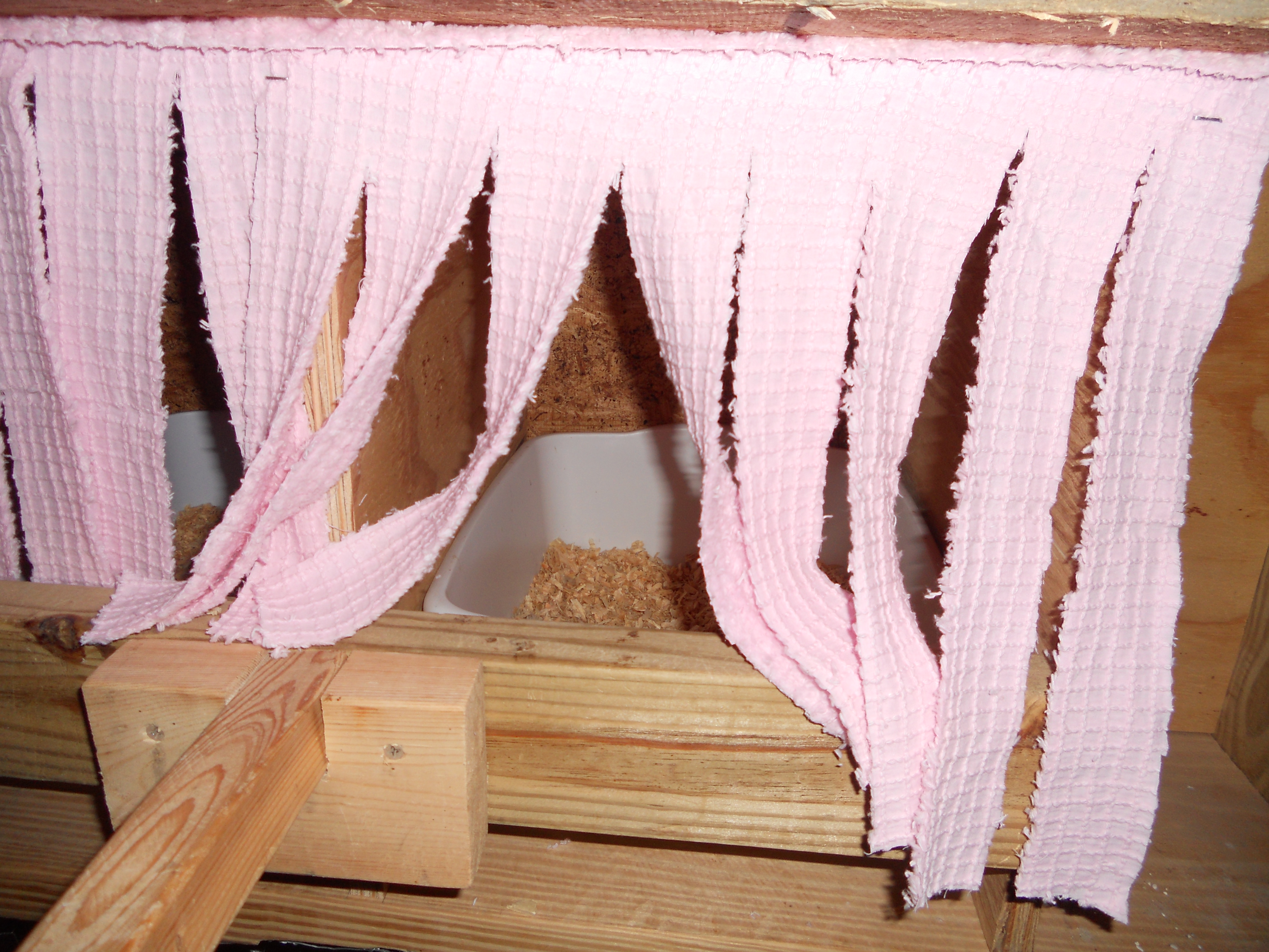 Close up of private nest box. I stapled fabric to the front and cut into strips. The next boxes are plastic dishpans that can be removed to clean.