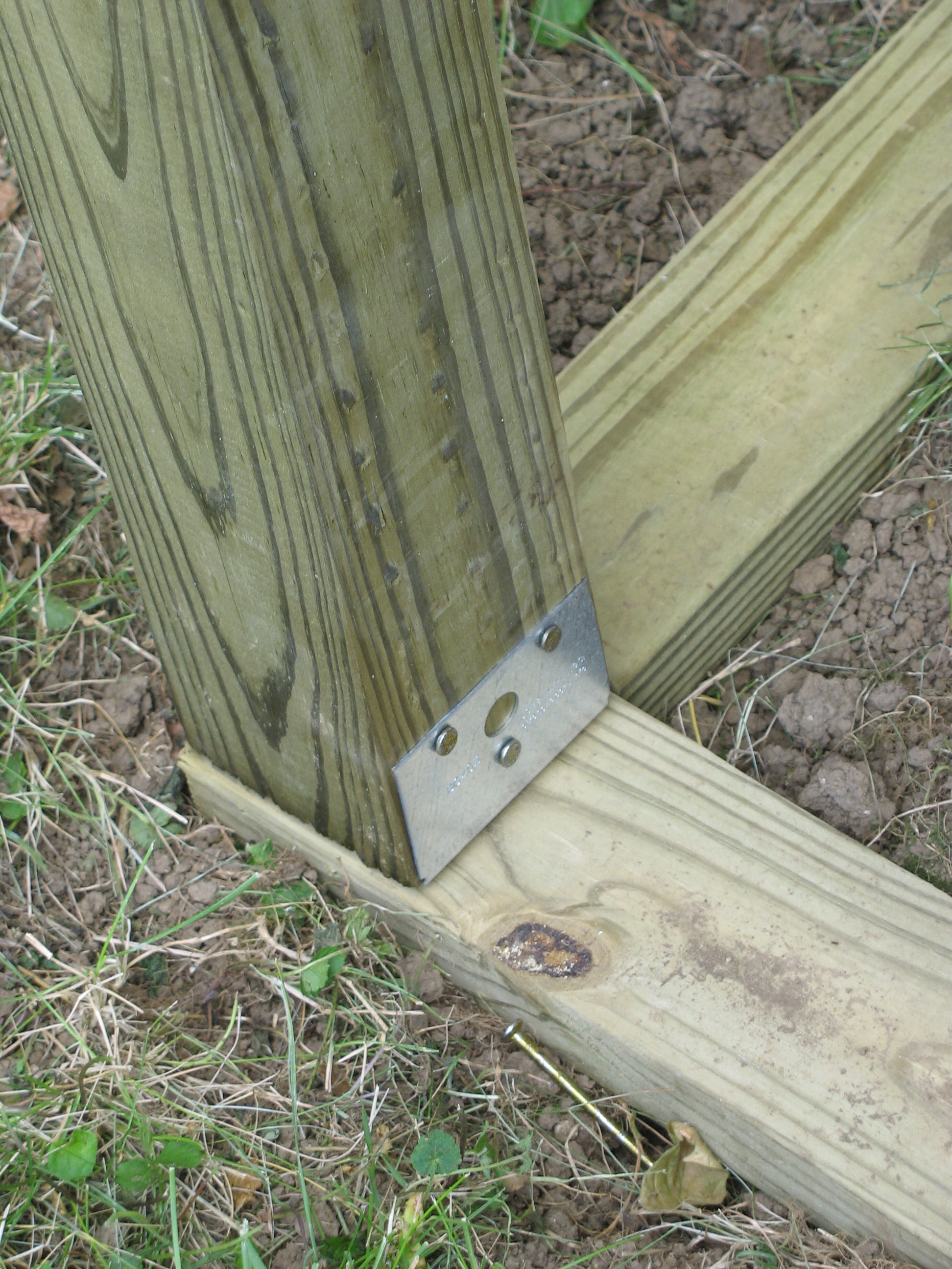 Close up of vertical 4x4s attached to foundation.