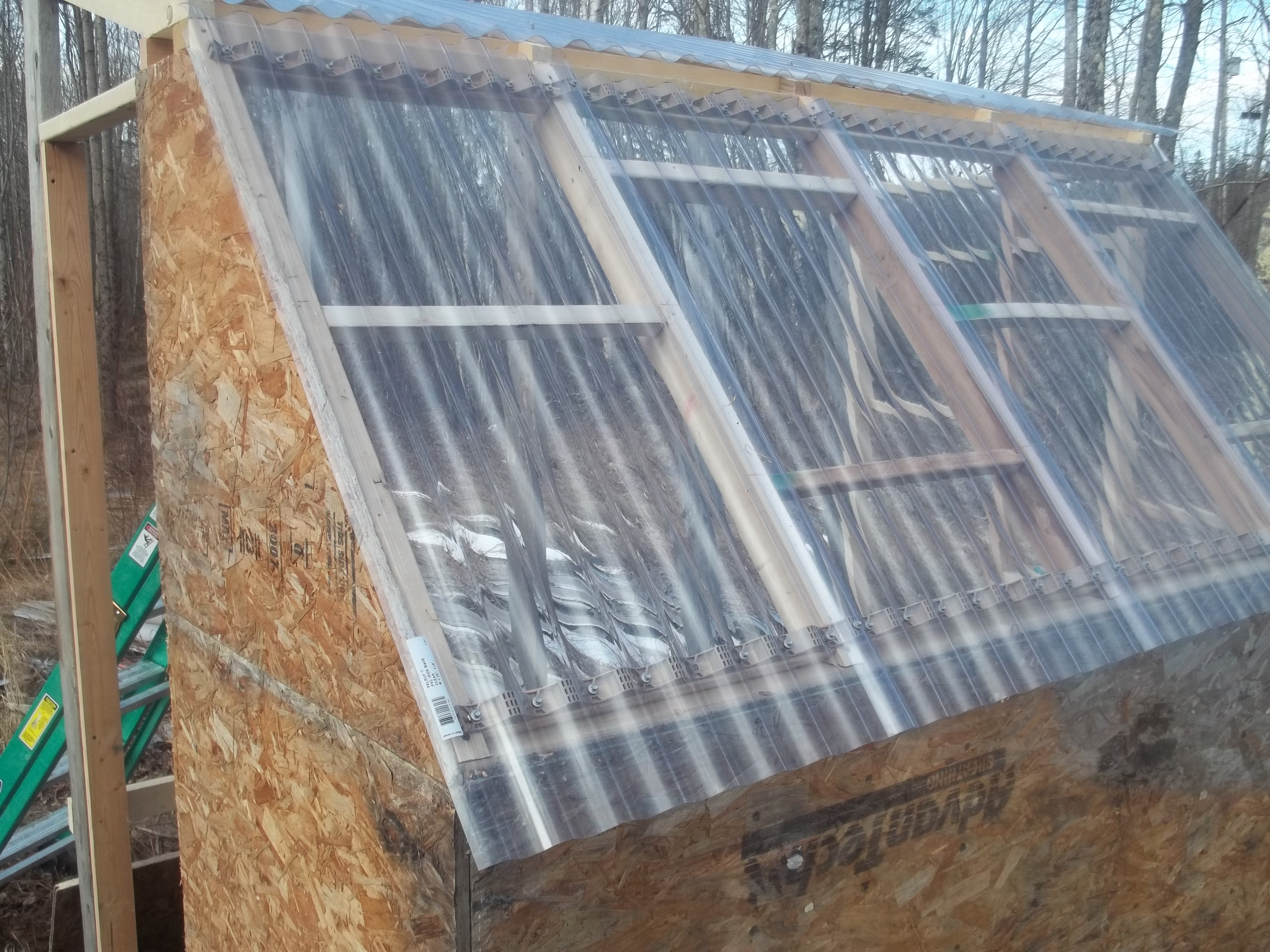 Closed up a little bit of the side with the door, and the upper roof is complete as well.  The lower edge of the upper roof overhangs at least 3 inches so no leaks!