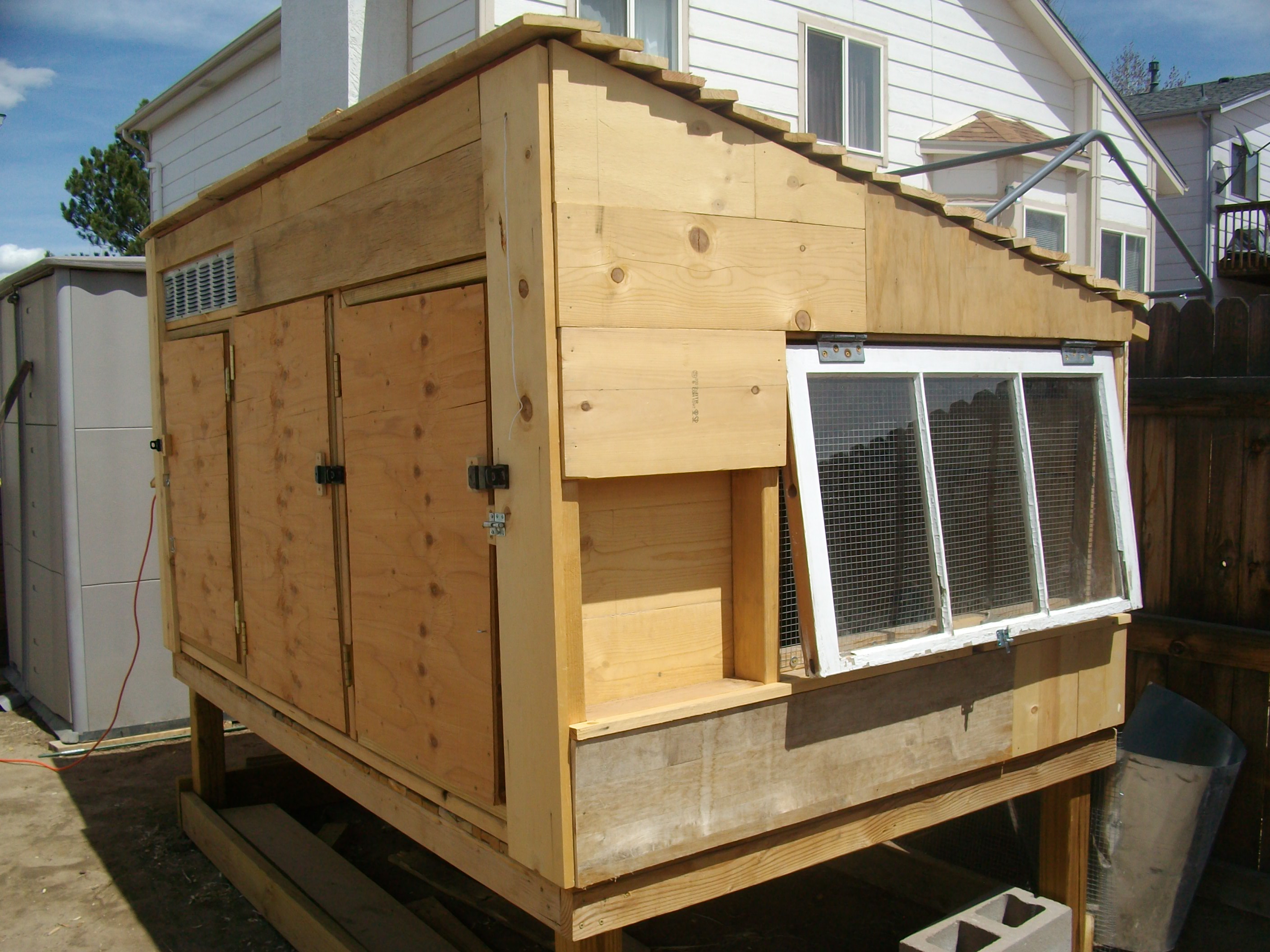 Coop with original roof made from reclaimed pallet wood.  It leaked like a sieve so I tore it off and installed corrugated metal.
