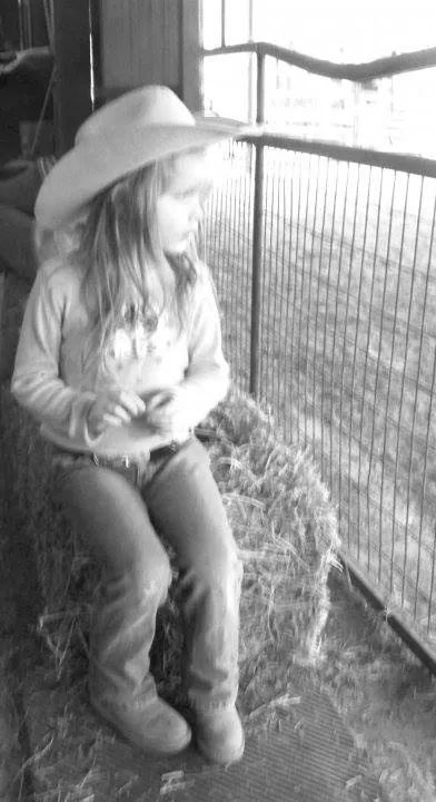 Dani watching her Daddy train horses.
