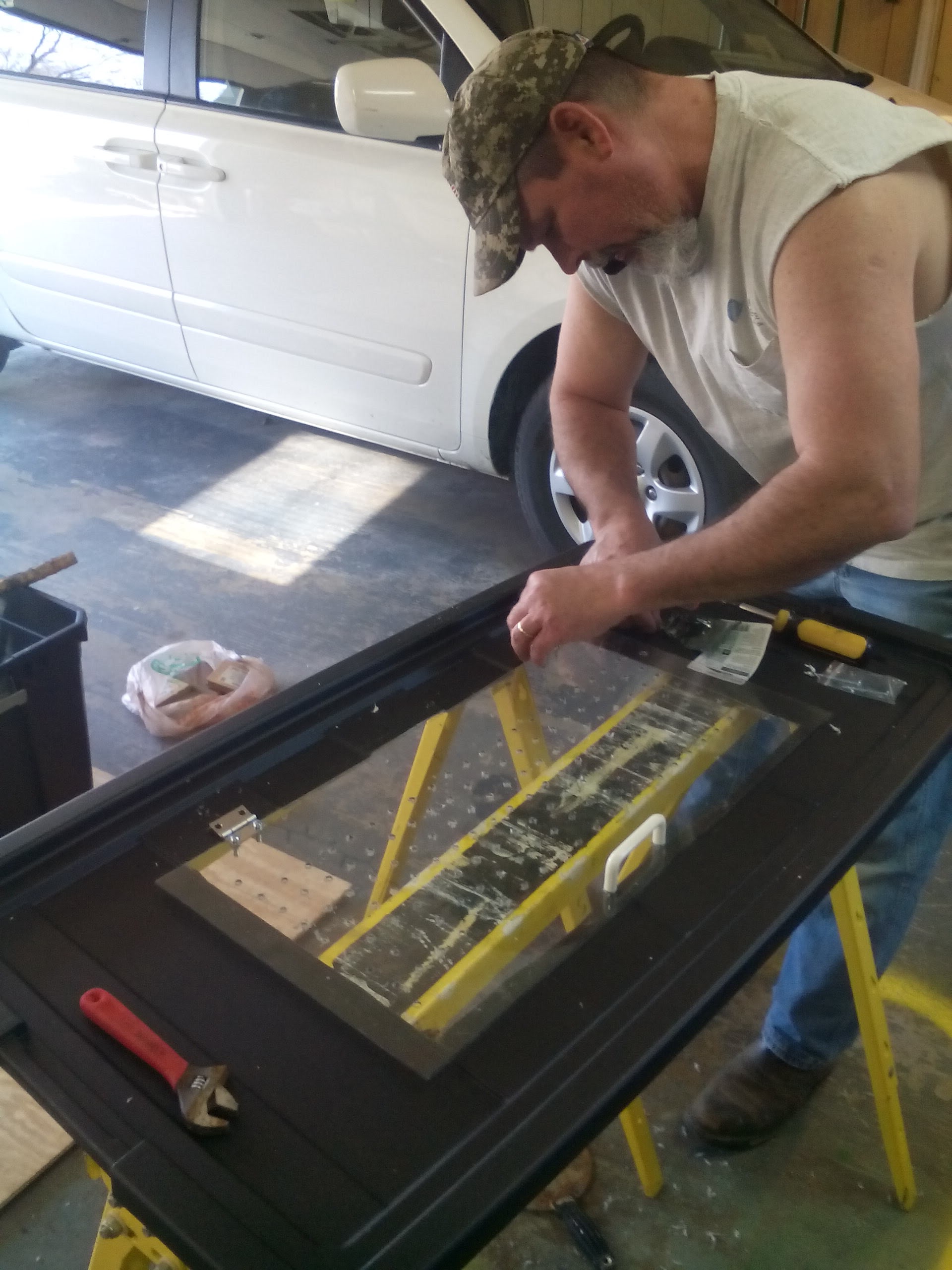 David working on our brooder box. We made it from a 50 gallon storage tub. Ideas were gathered from this website.