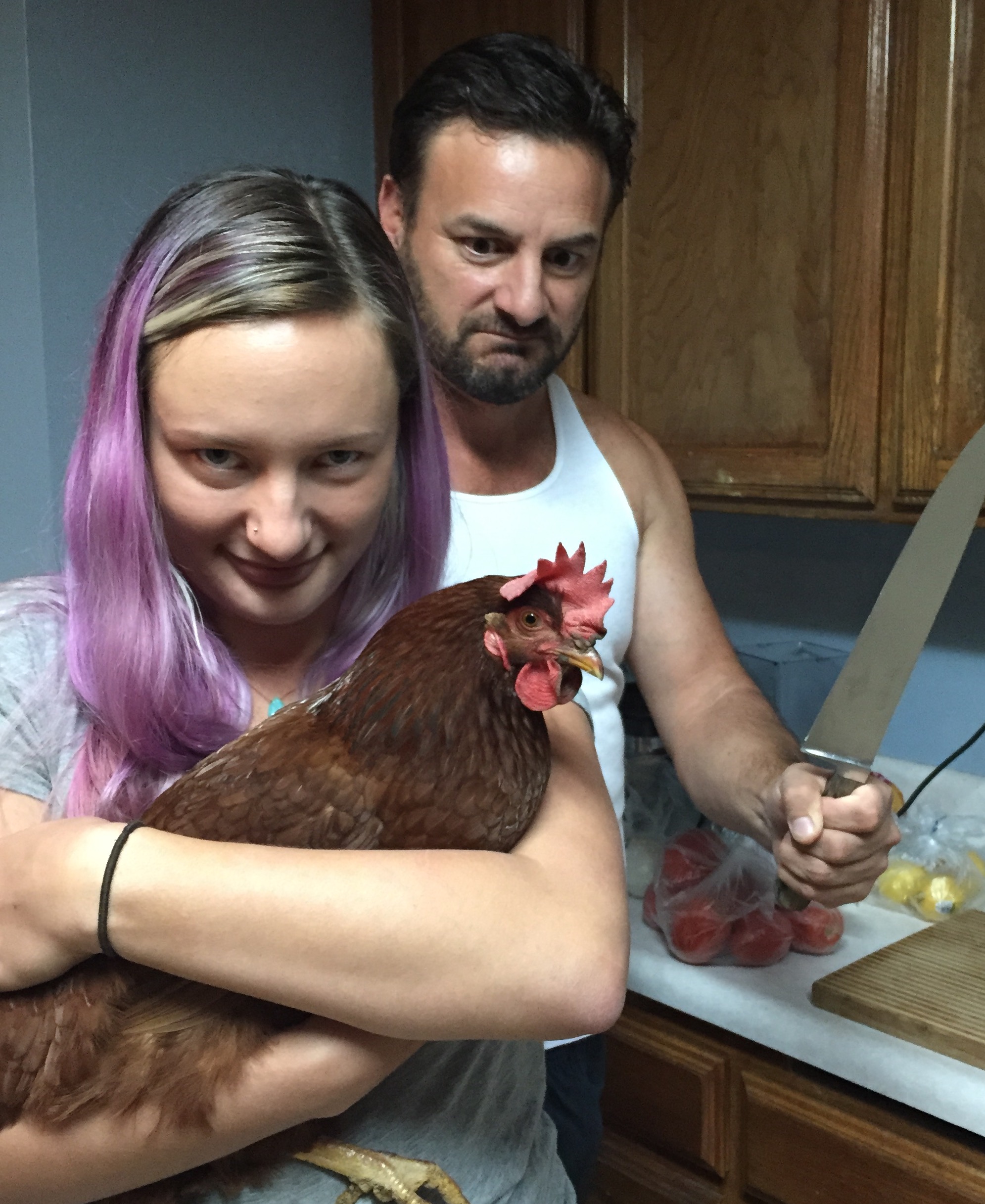 "Demi" posing with my husband and daughter. She's back in the coop