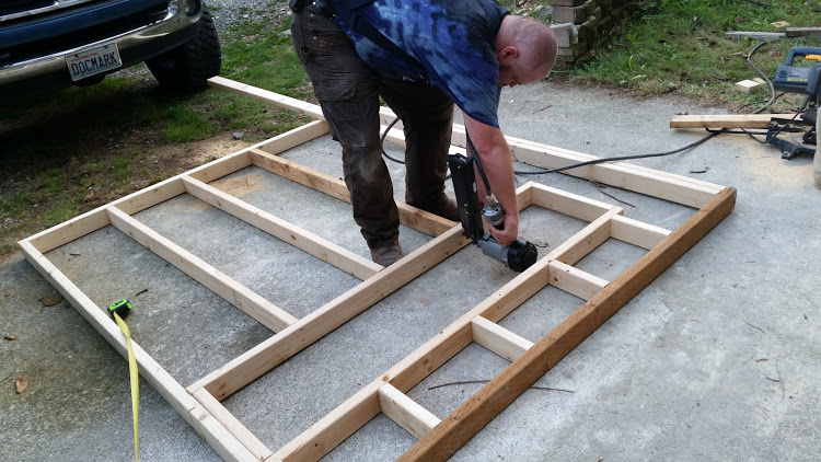 DH framing the inside wall - separating coop from garden shop