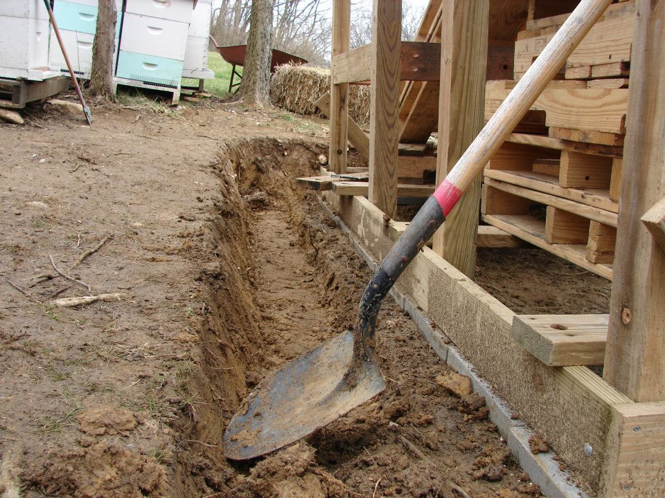Digging drain tile.