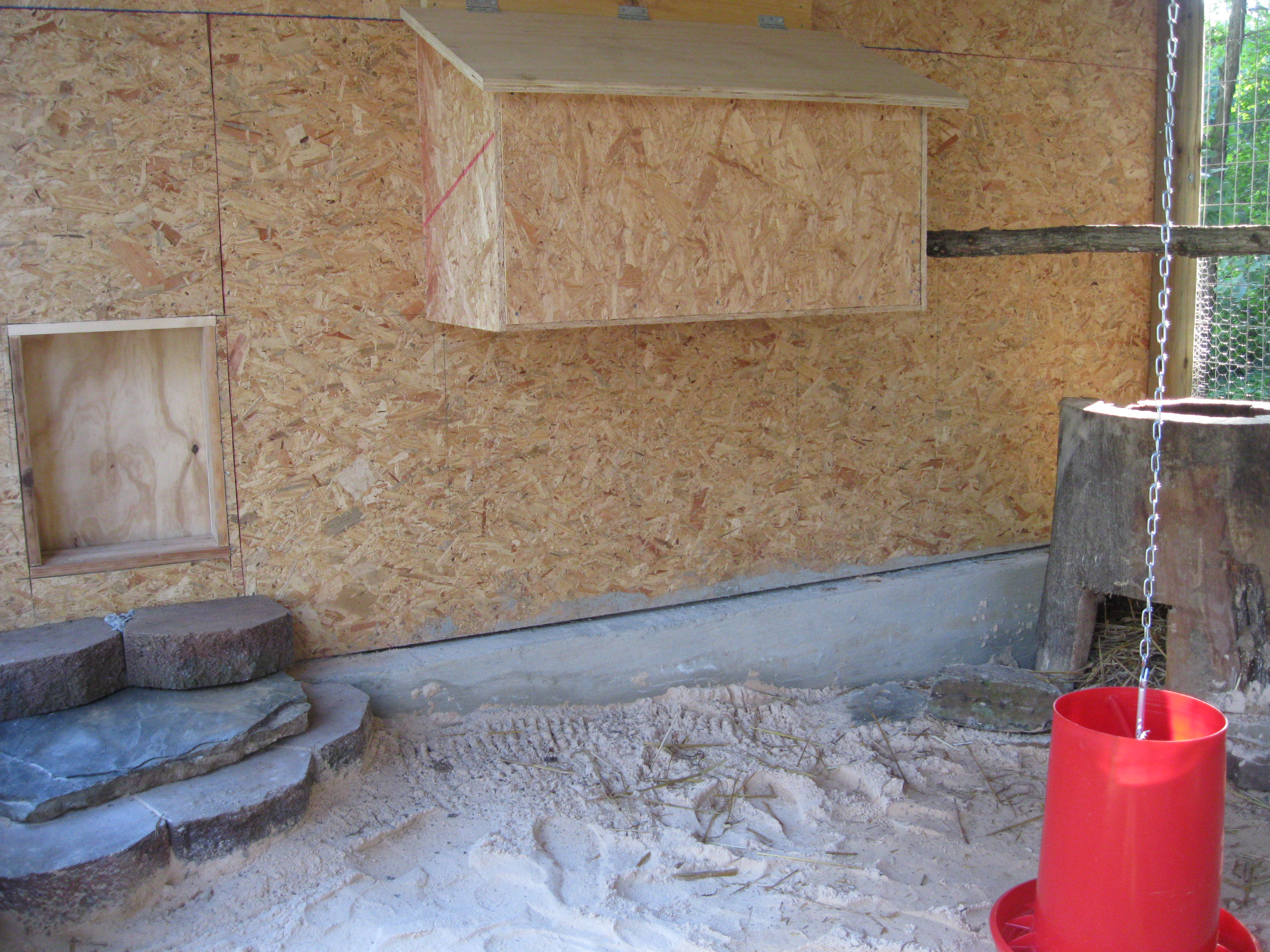 Don't know if they'll use it, but that door on the left goes into the coop.  The door is attached to a pulley system and can be raised and/or lowered from outside the setup.  That's a nesting box which is in the coop but can be accessed from the run. Again, don't know if the pheasants will use that?  We found a hollow tree and cut the "stump" which we're hoping she'll nest in or at least "escape" to ~  It's got a good thick layer of straw in the bottom.
