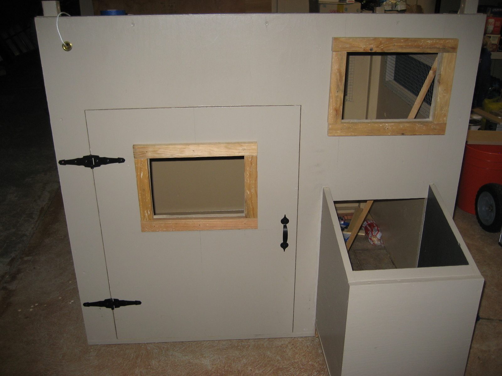 Door installed, nest box installed. I also decided that I wanted some windows in the front of the coop so that I could peek at the chickens.