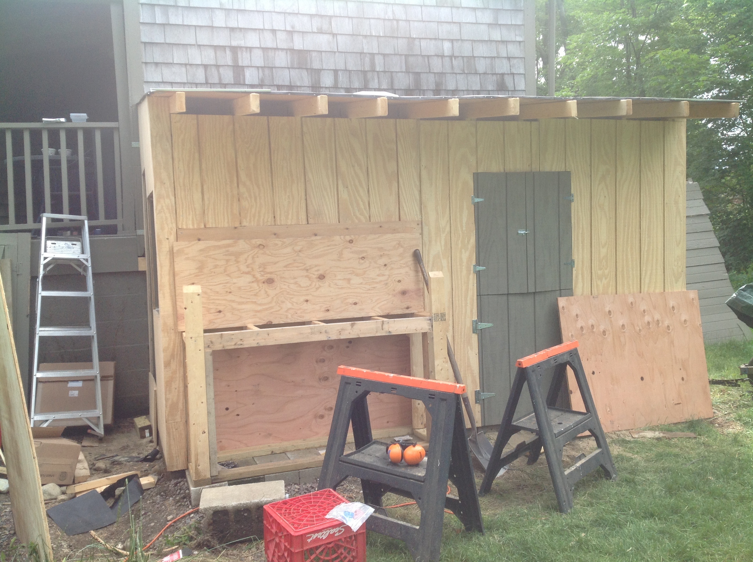 Door is actually an operating window on top and below a clean out door.  Pen fetching on side, allowing easy access to door.  Nesting box on left with supply cabinet below.