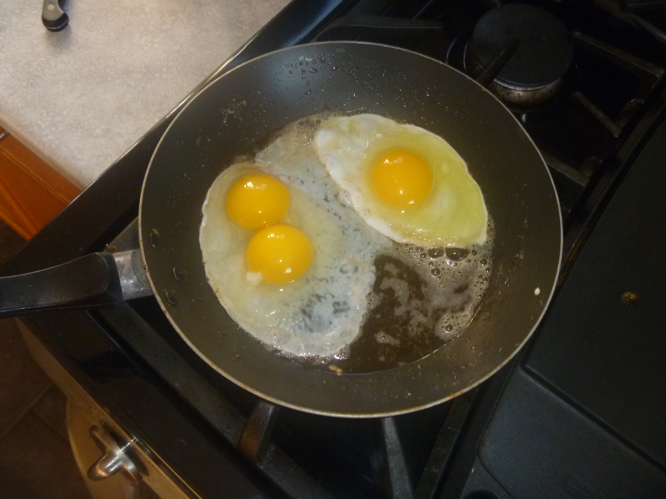 Double yoker beside one of my regular eggs.