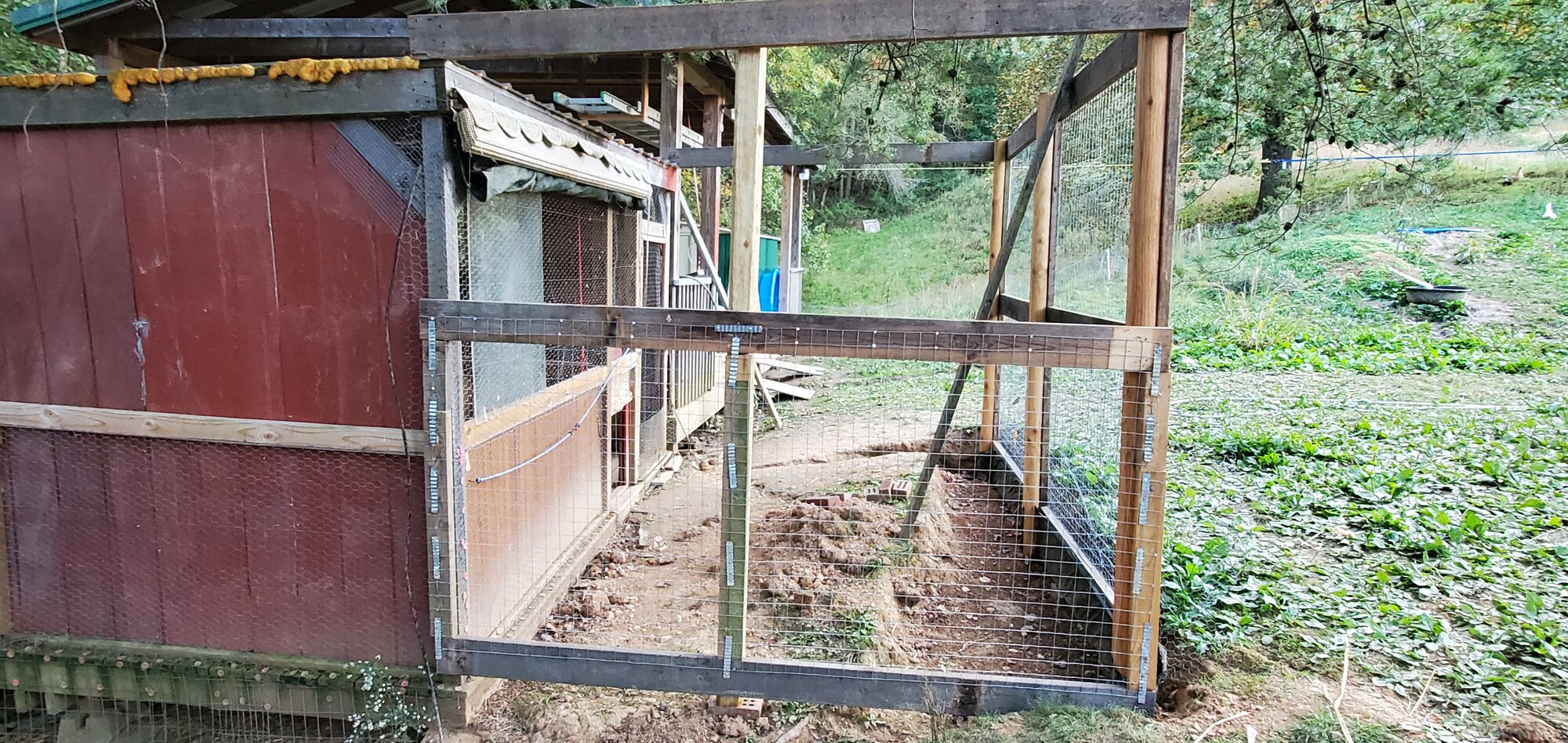 East sidewall is framed and ½ covered in 2x2" welded wire-mesh