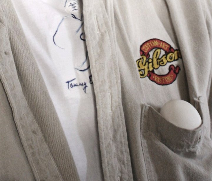 Egg listens as farmer John plays the guitar.