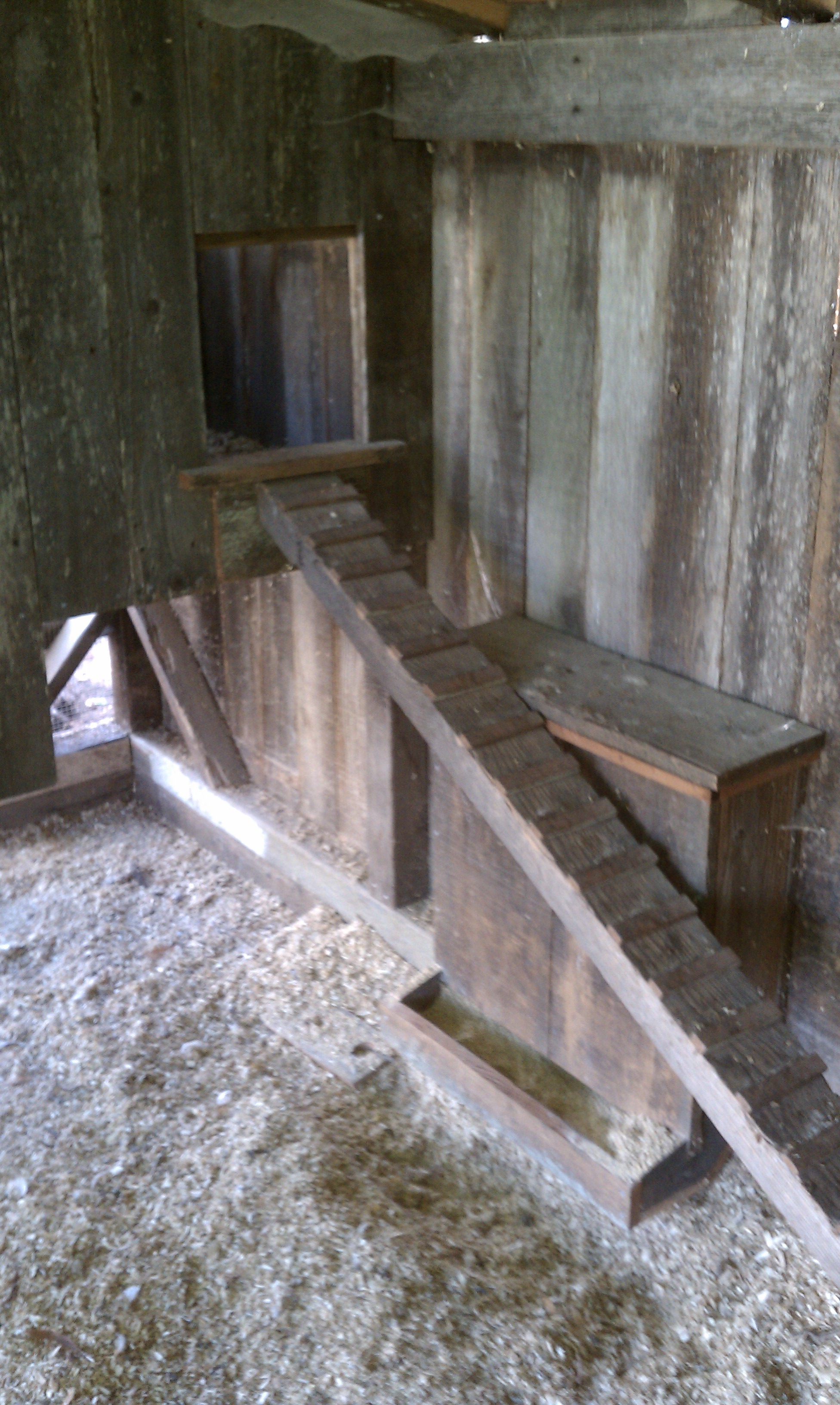 Entrance to sleeping quarters and homemade feeder for 50# sack.