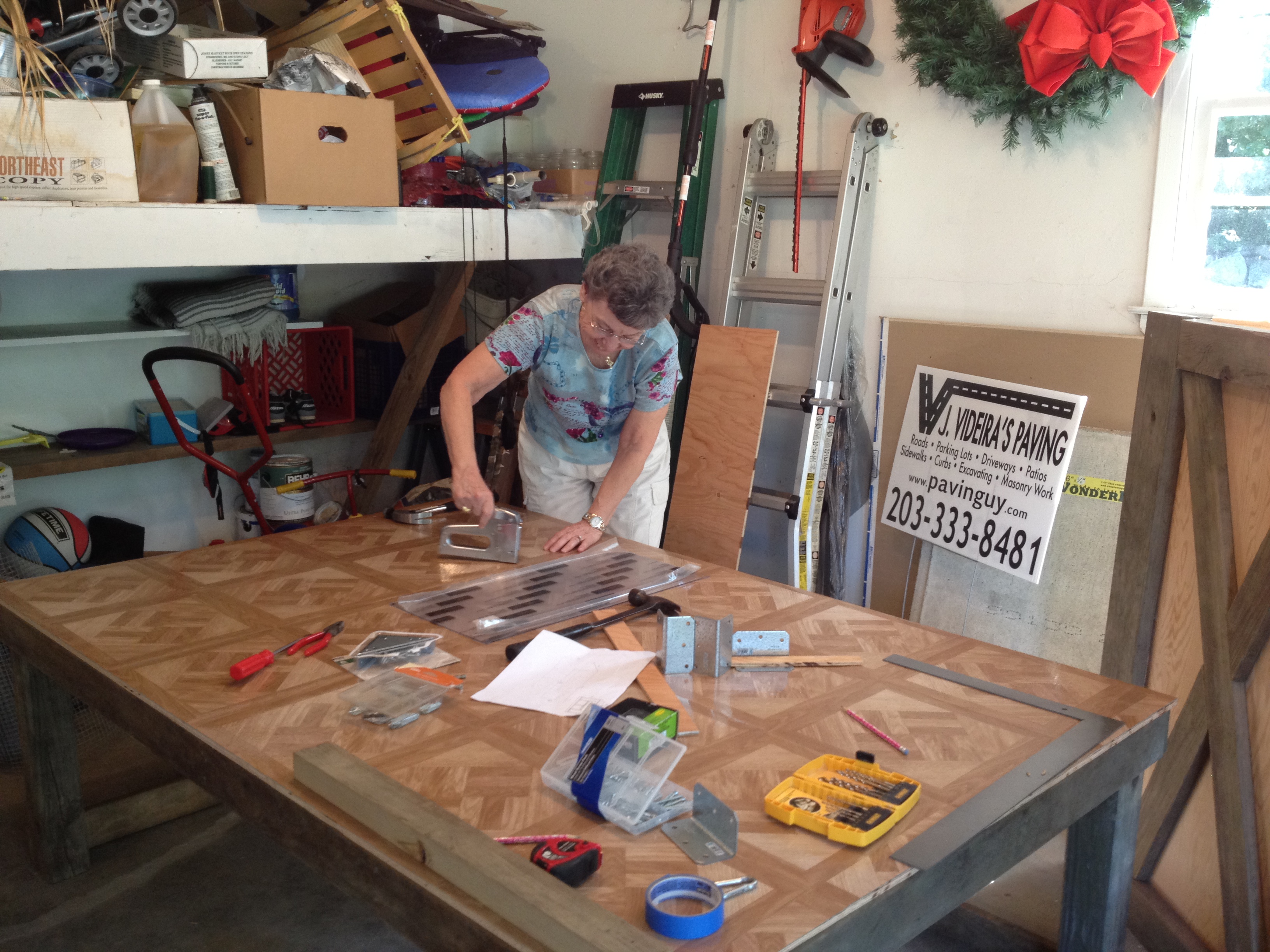 Even my mom helped out - here she's stapling down the peel and stick tiles that unfortunately didn't stick :(