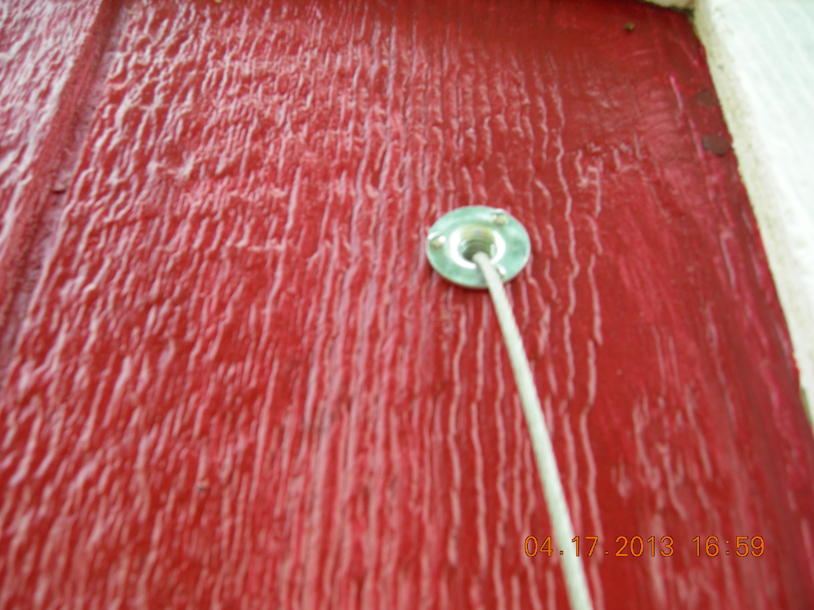 Eyelet on outside of coop. Keeps the wire from messin up the wood.