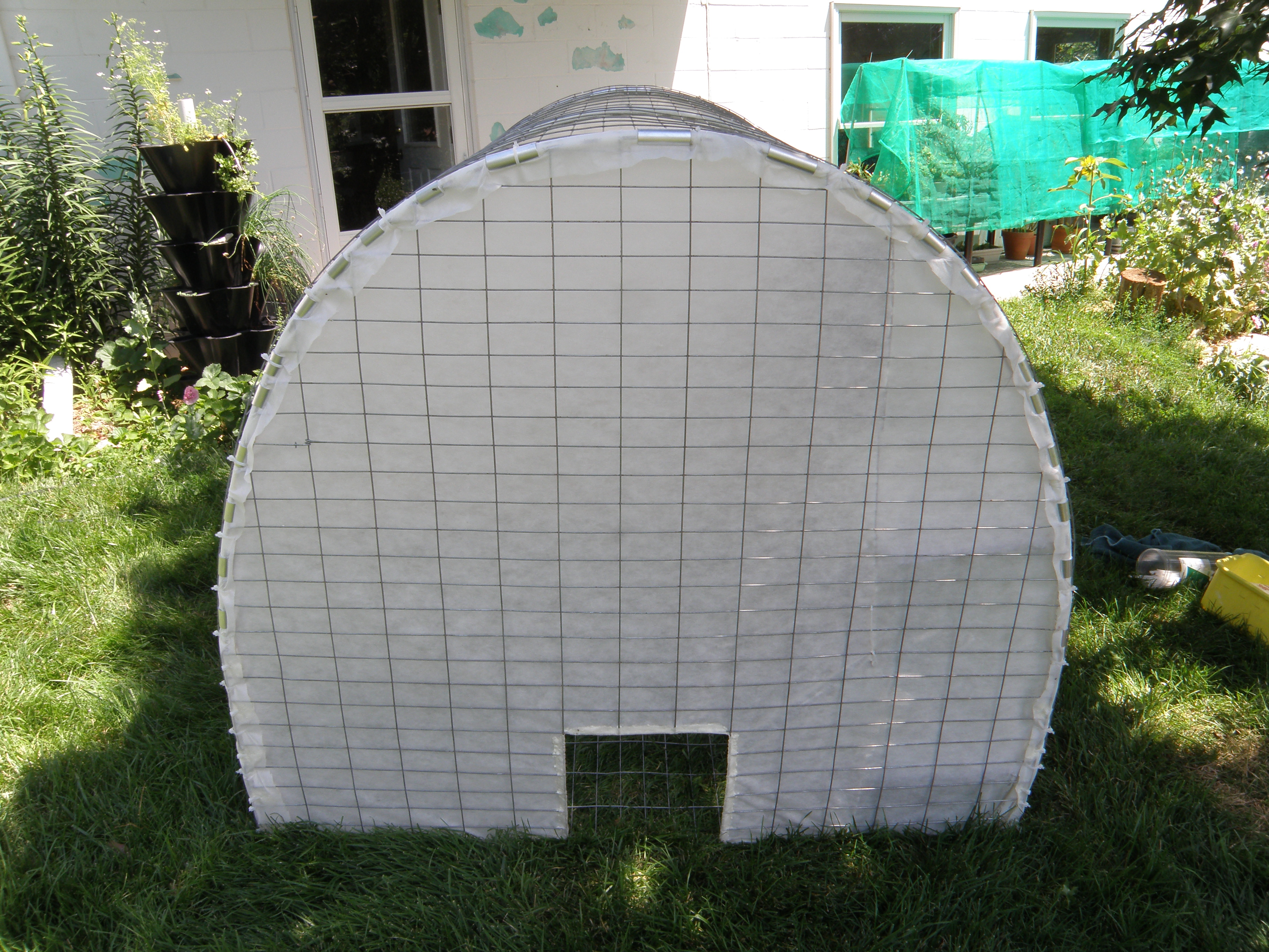 Fabric cover coop end secured with tube fabric clips