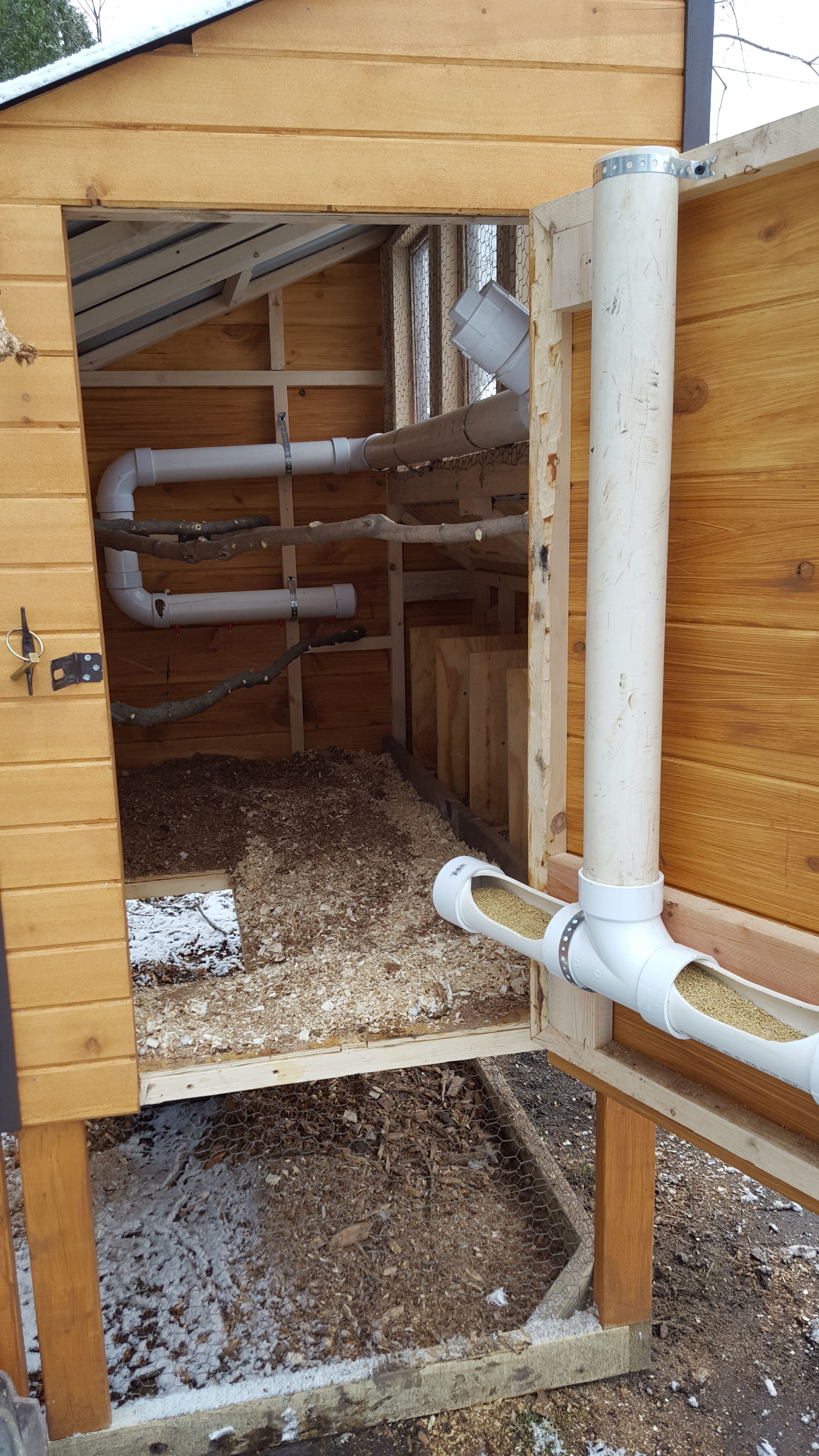 Feed and water setup.  The water system holds about 5 gallons and has not been a problem yet.  There are 3/4" holes drilled through the floor directly below the nipples.  Keeps everything pretty dry.