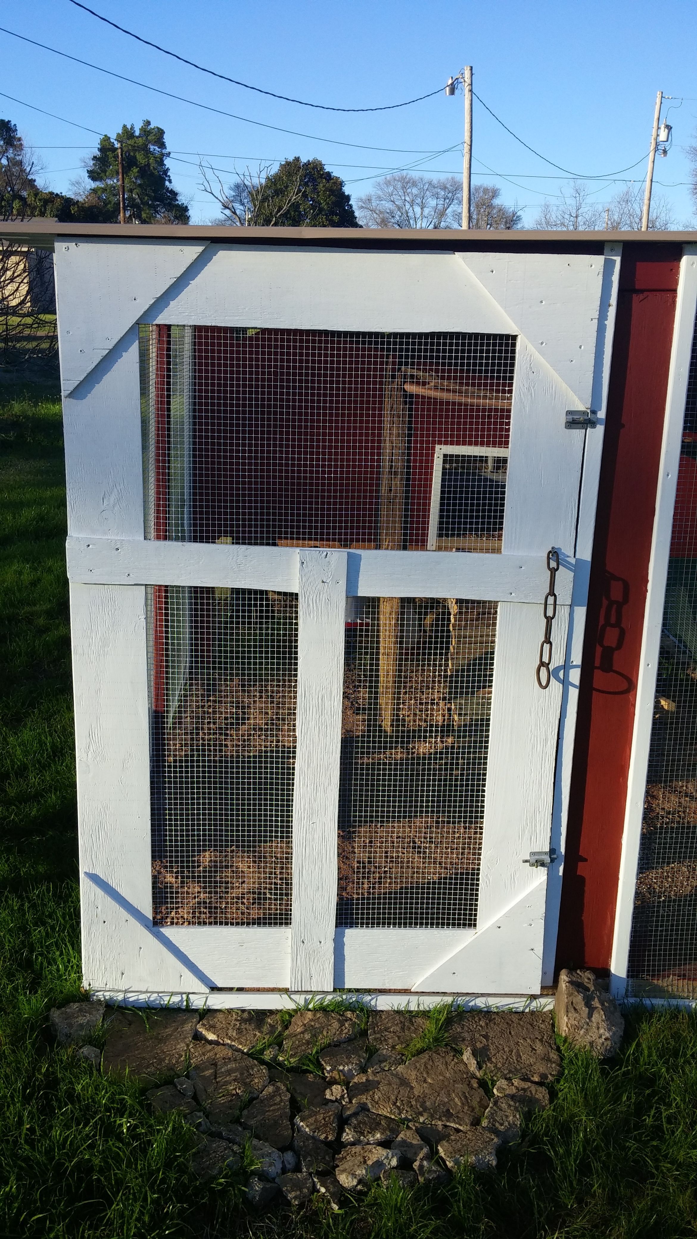 Finished screen door built with leftover plywood and the handle is a chain I found embedded in a tree which had fallen years ago and rotted, I just pulled the chain out of the wood.