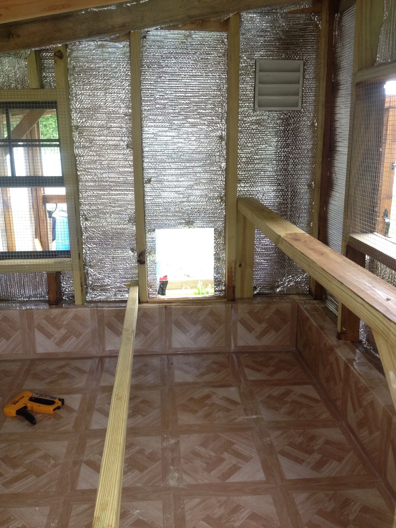 Foil insulation and linoleum tile installed