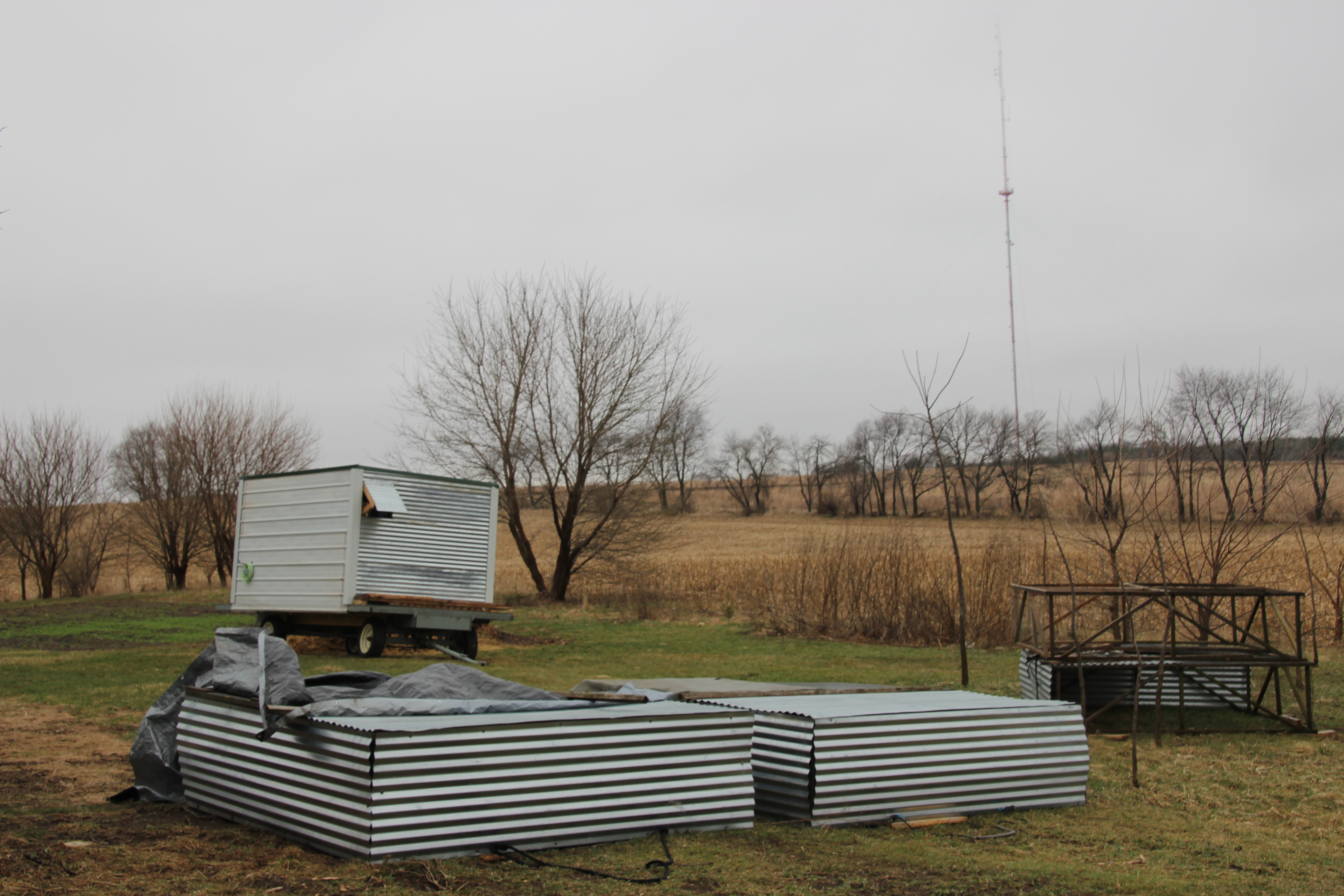 Foreground: 7 year old chicken tractors... still going strong!  2017 Batch #1 is finally on grass!  Background: Our winter-ready mobile chicken coop, ready for the combined grow-out.