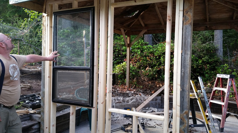 Framing has begun!  Yeah!  Testing window fit.  An excellent deal for all these windows from a local ad... win-win.  Classy hen house with excellent ventilation, light and cross breeze.