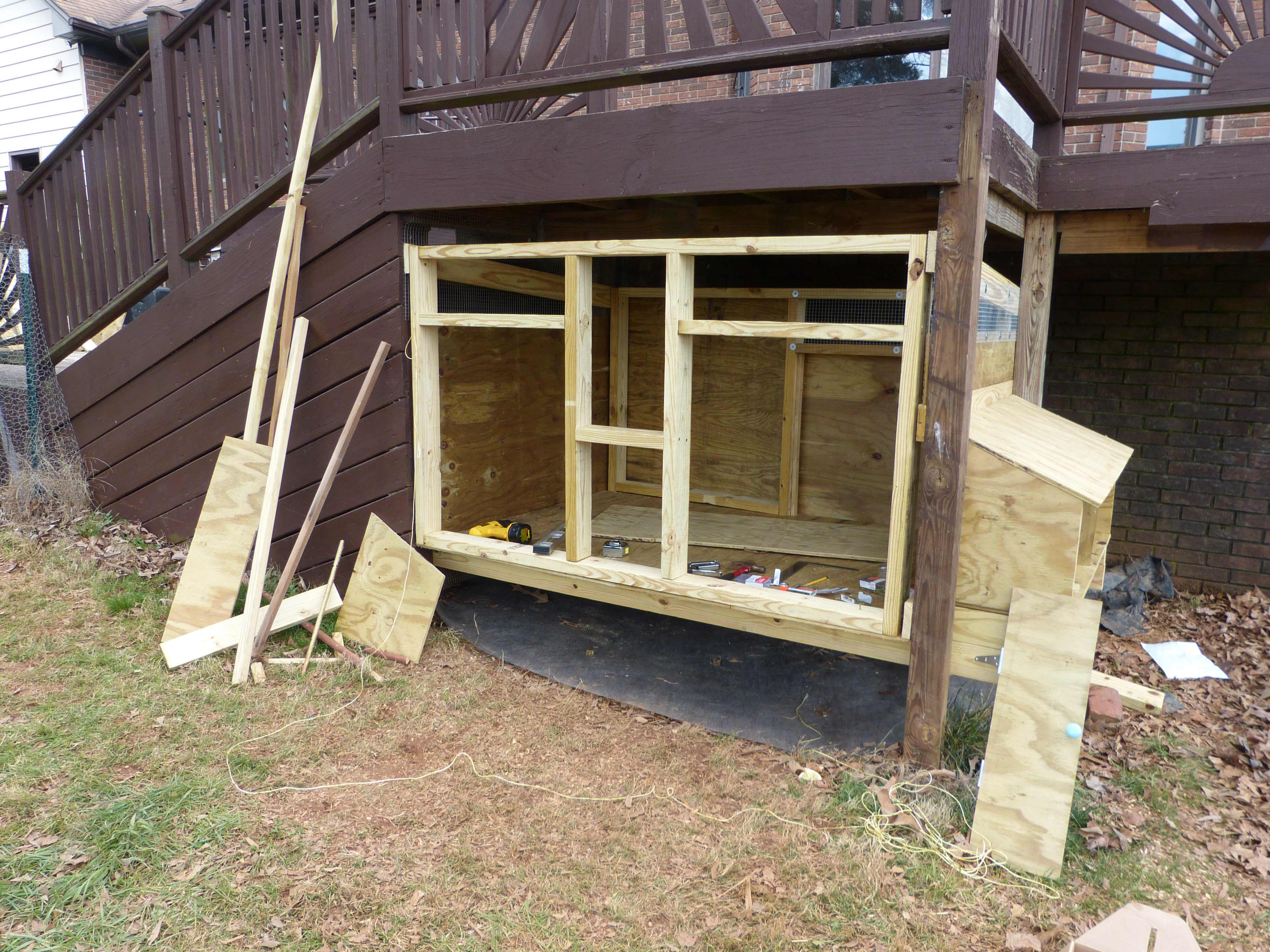 framing the face with another clean out door, a pop door, a window and a closed side nearest the nest boxes