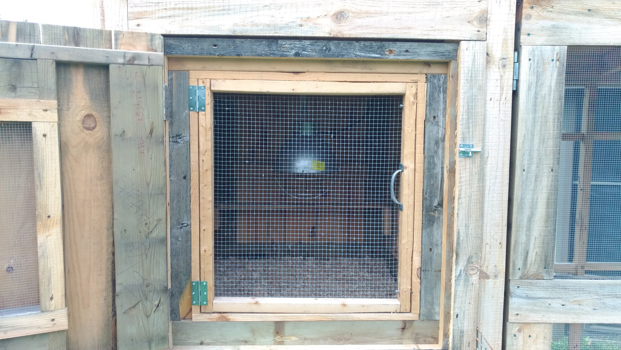 Front of coop house with first /screen door closed