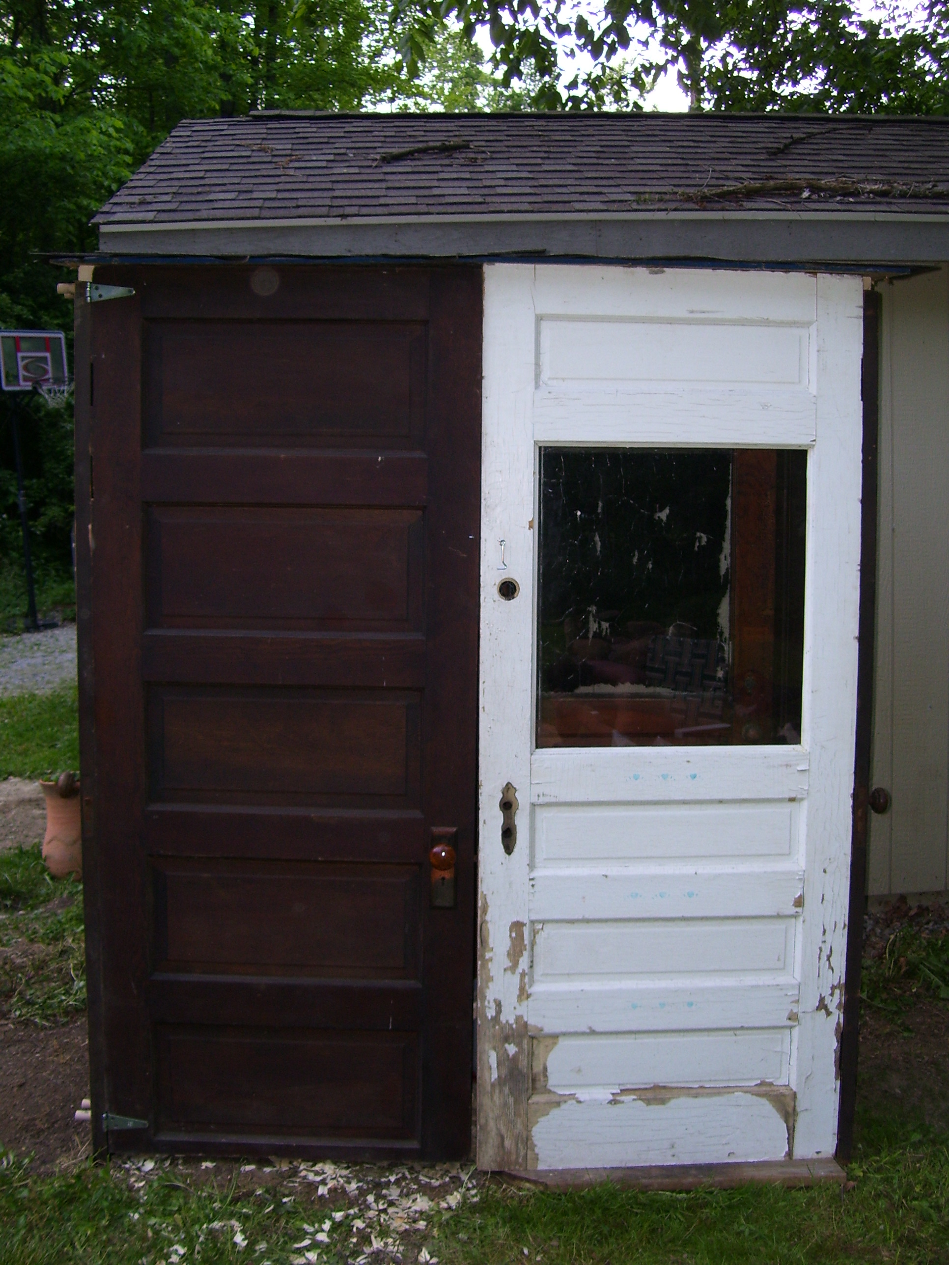 front of coop, left door opens. We r going to make a small opening in the right door for them so they can go in and out during the day, without leaving the big door open :)