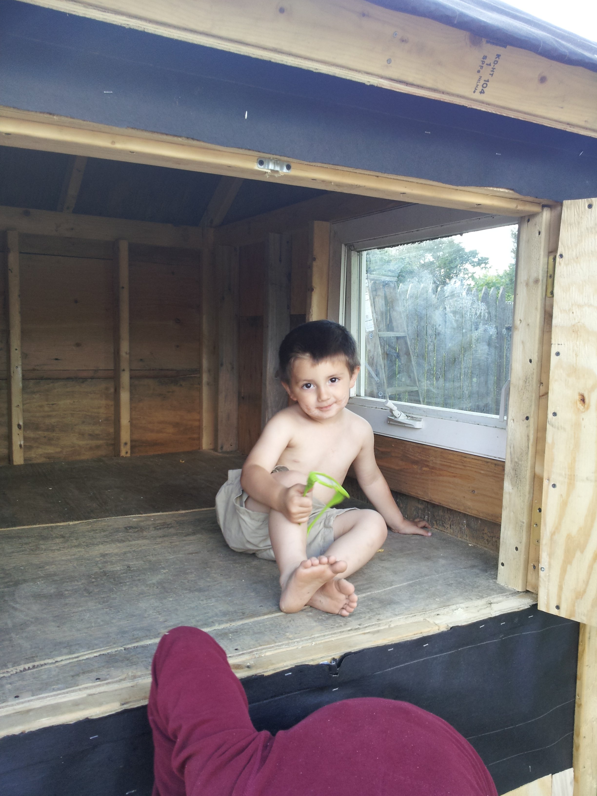 Getting nauseous yet?  All salvaged materials minus the paper and shingling.. that's our old bathroom window.. and of course my 3 1/2 yr old son hanging out.
