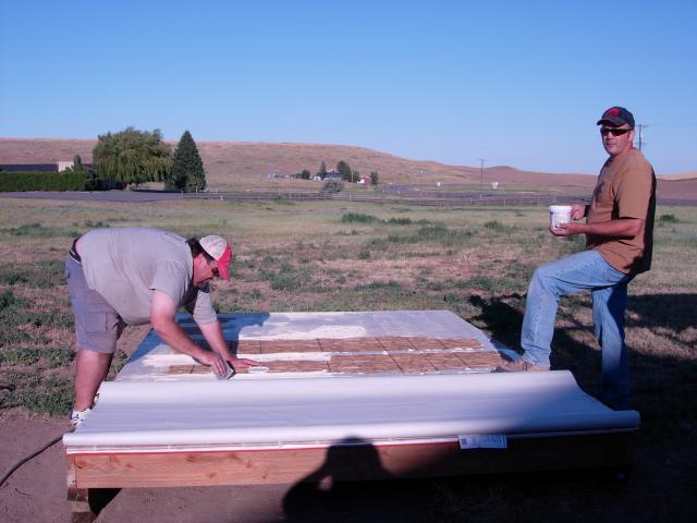 Gluing the linoleum flooring down before we put the walls up.  Got a great deal at Lowes!