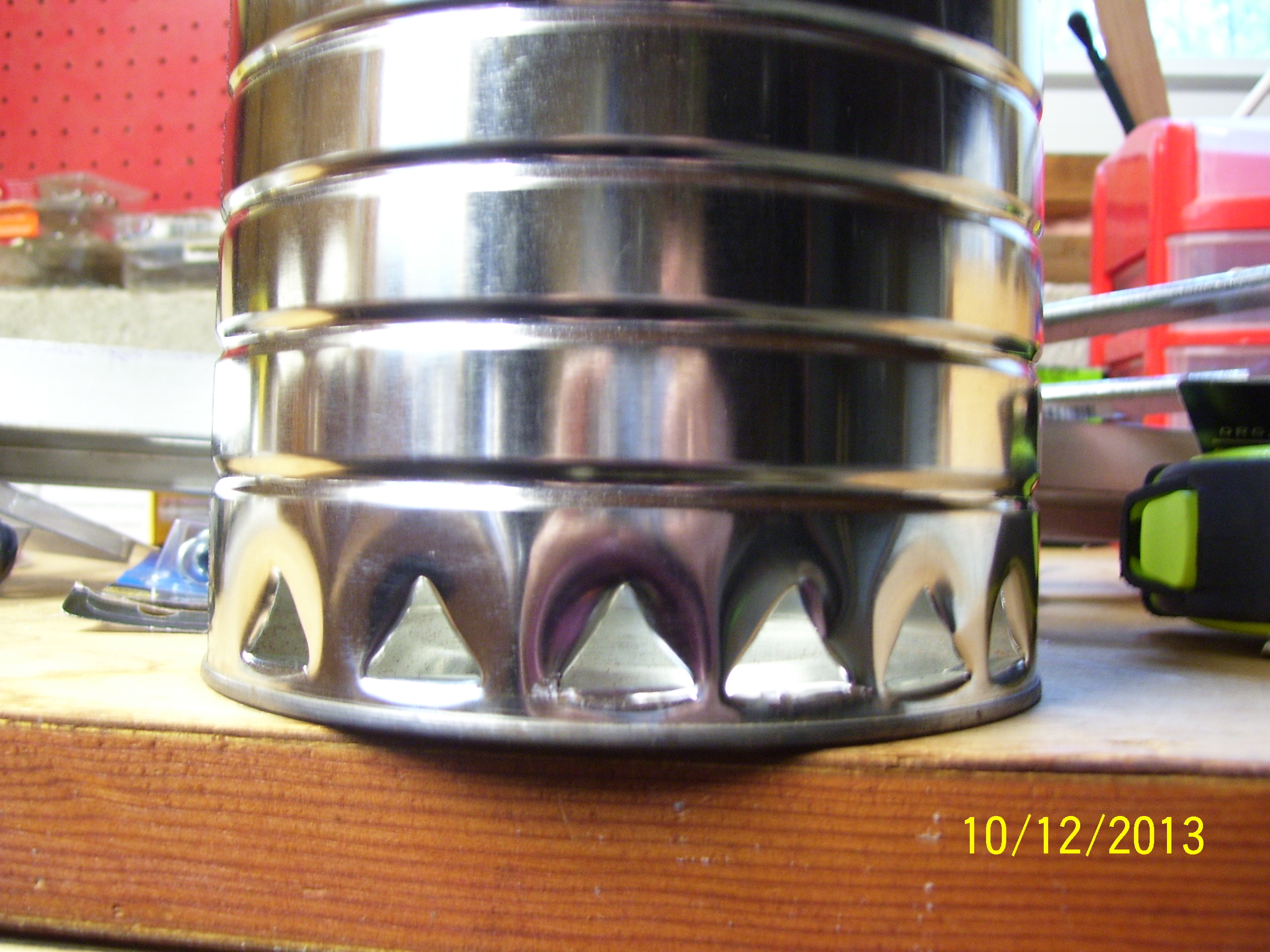 grit or oyster shell dispenser. Coffee can, openings along the bottom punched in with "church key."