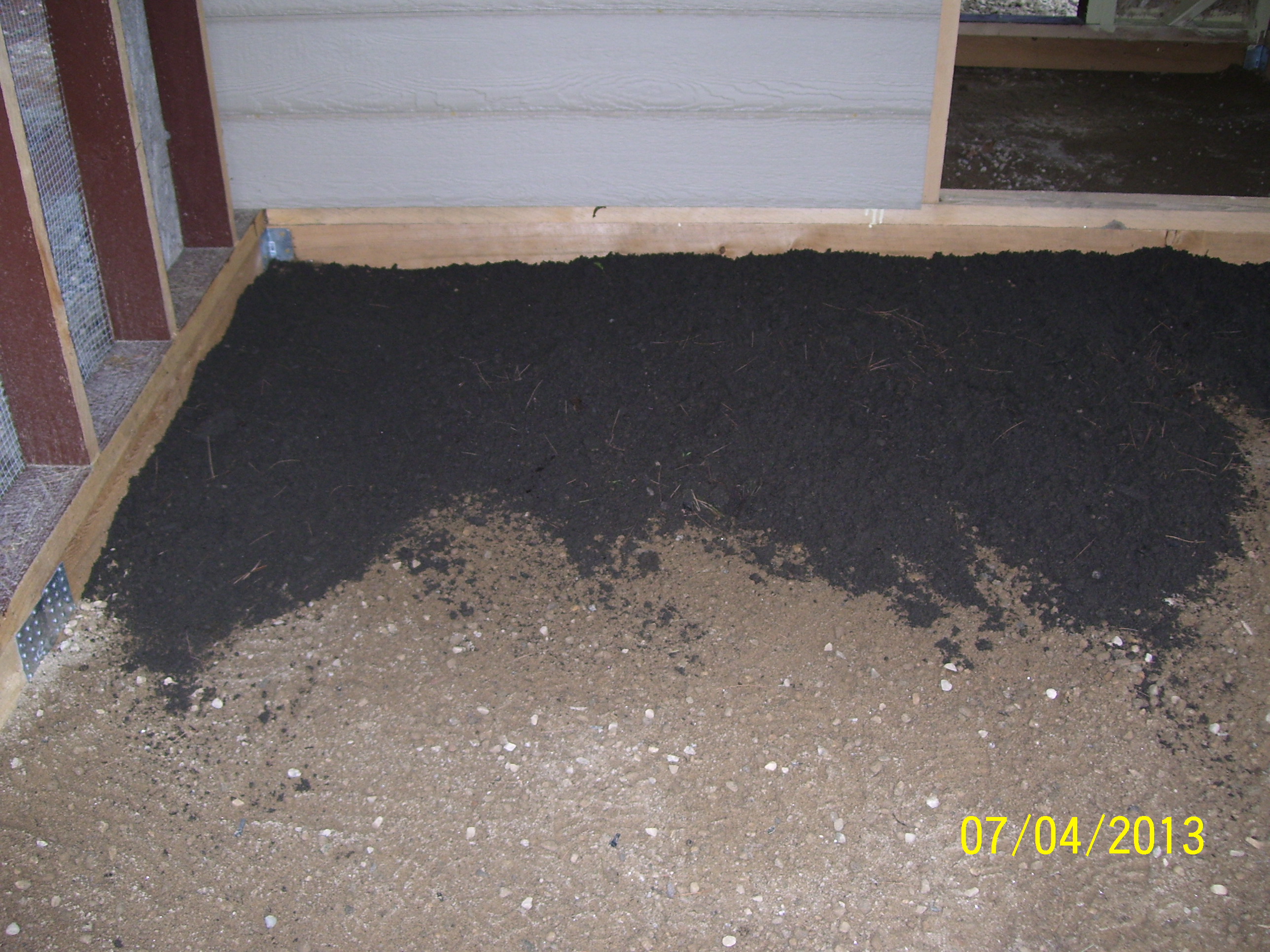 Hardware cloth over gravel and more gravel, then loam, then leaves on top.