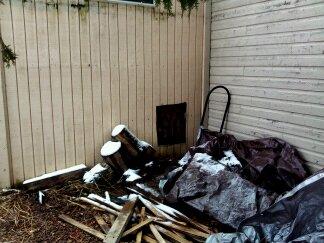 Hen door used to be covered by wood pile which I have  been depleting this winter. Coop is 10' X 8' and and is attached to a garage. I can put a 12' X 8' covered run here and continue on around the front of the garage another 20'.