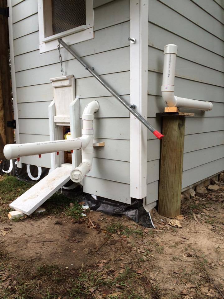 Here you can see our watering system. Fill it outside, it runs inside then back out. There are 6 drippers inside and 6 outside. We even made a lower section for the bantams. We put a removable cap at the lowest point so we can clean it out. The whole system hold about 8 gallons.