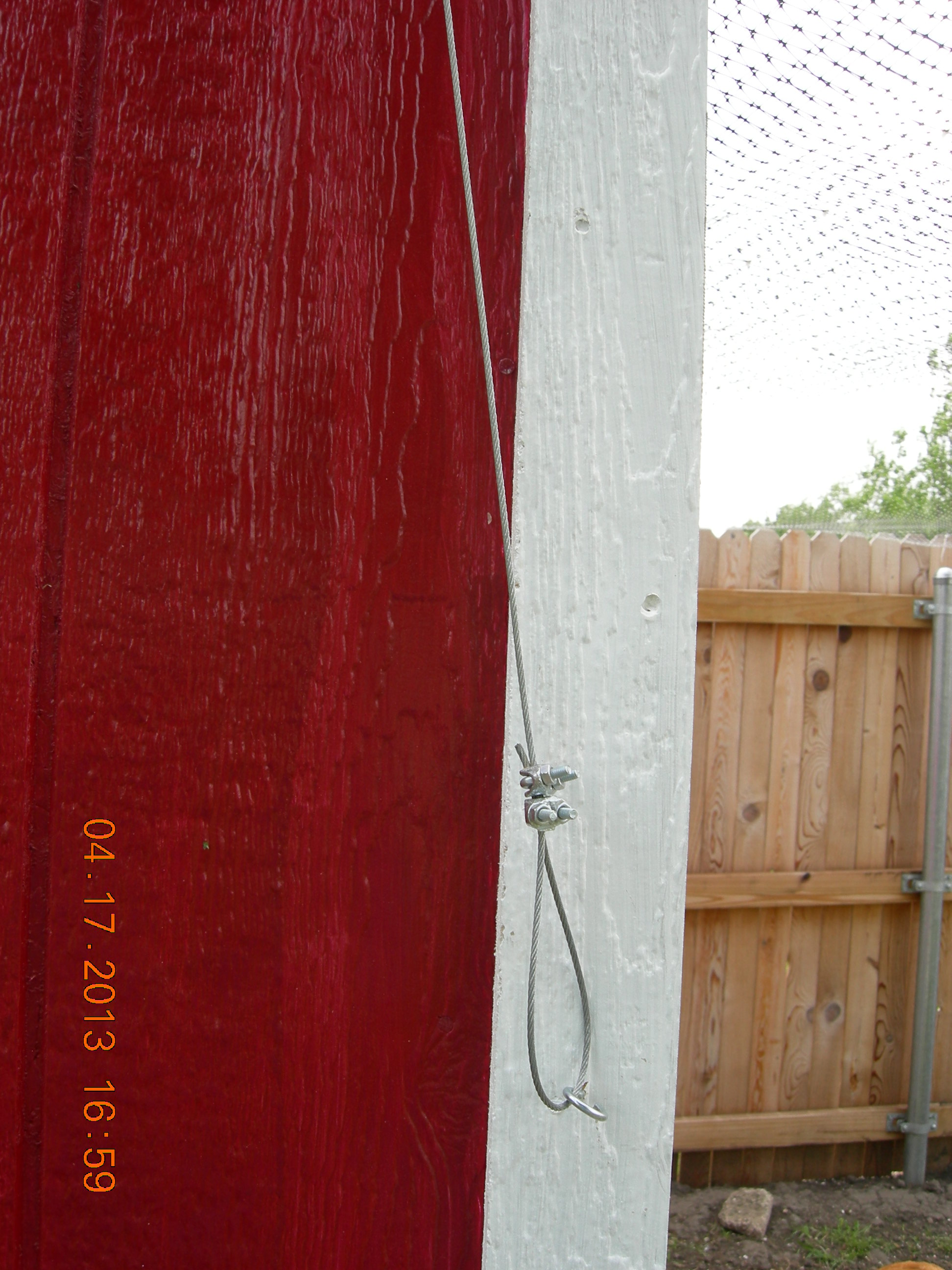 Here's the wire loop that I pull and attach to the hook to open the pop door in the morning and then in the evening I unhook it and slowly lower it once the girls are all tucked in bed.