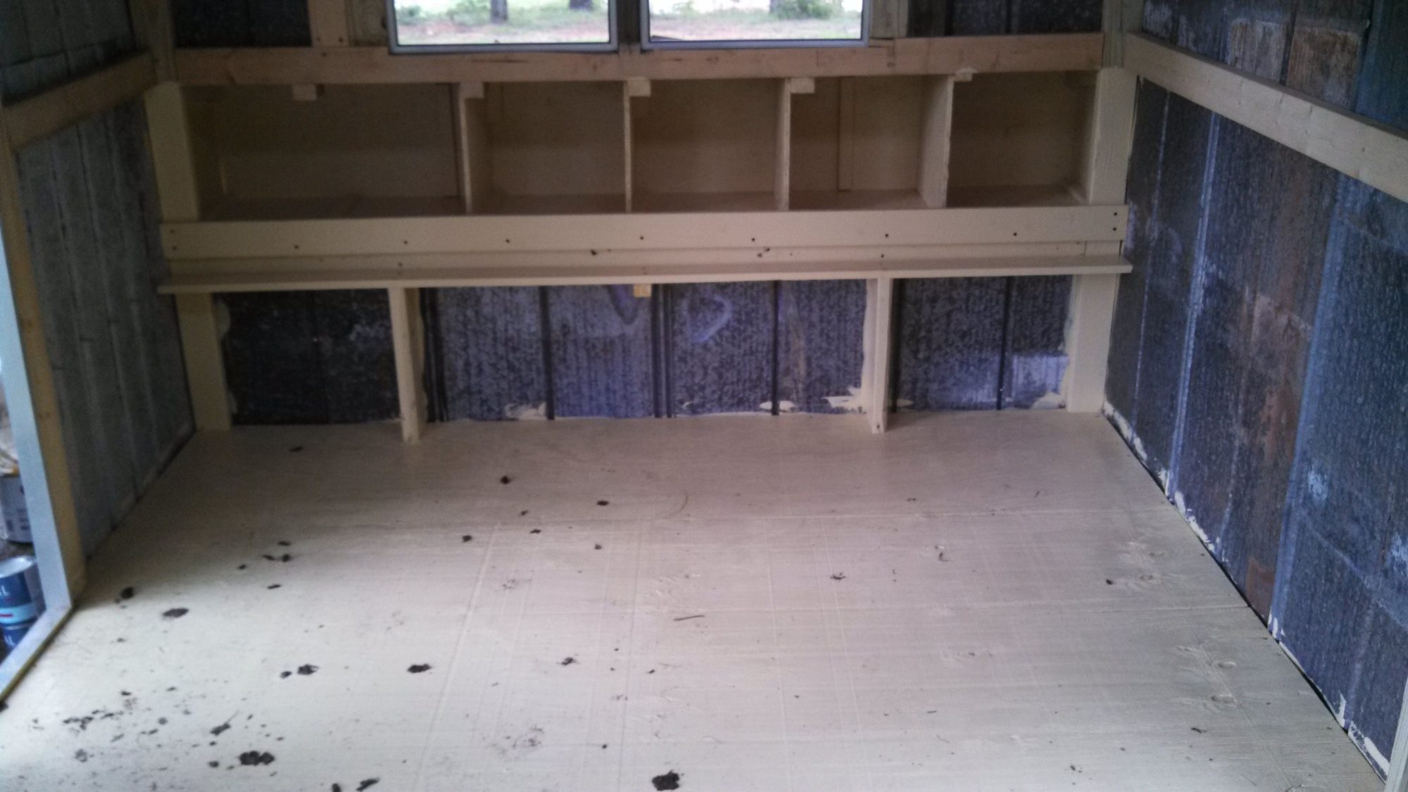 I also painted the floor to seal it. The girls tried their new floor out before I got the shavings put down.
