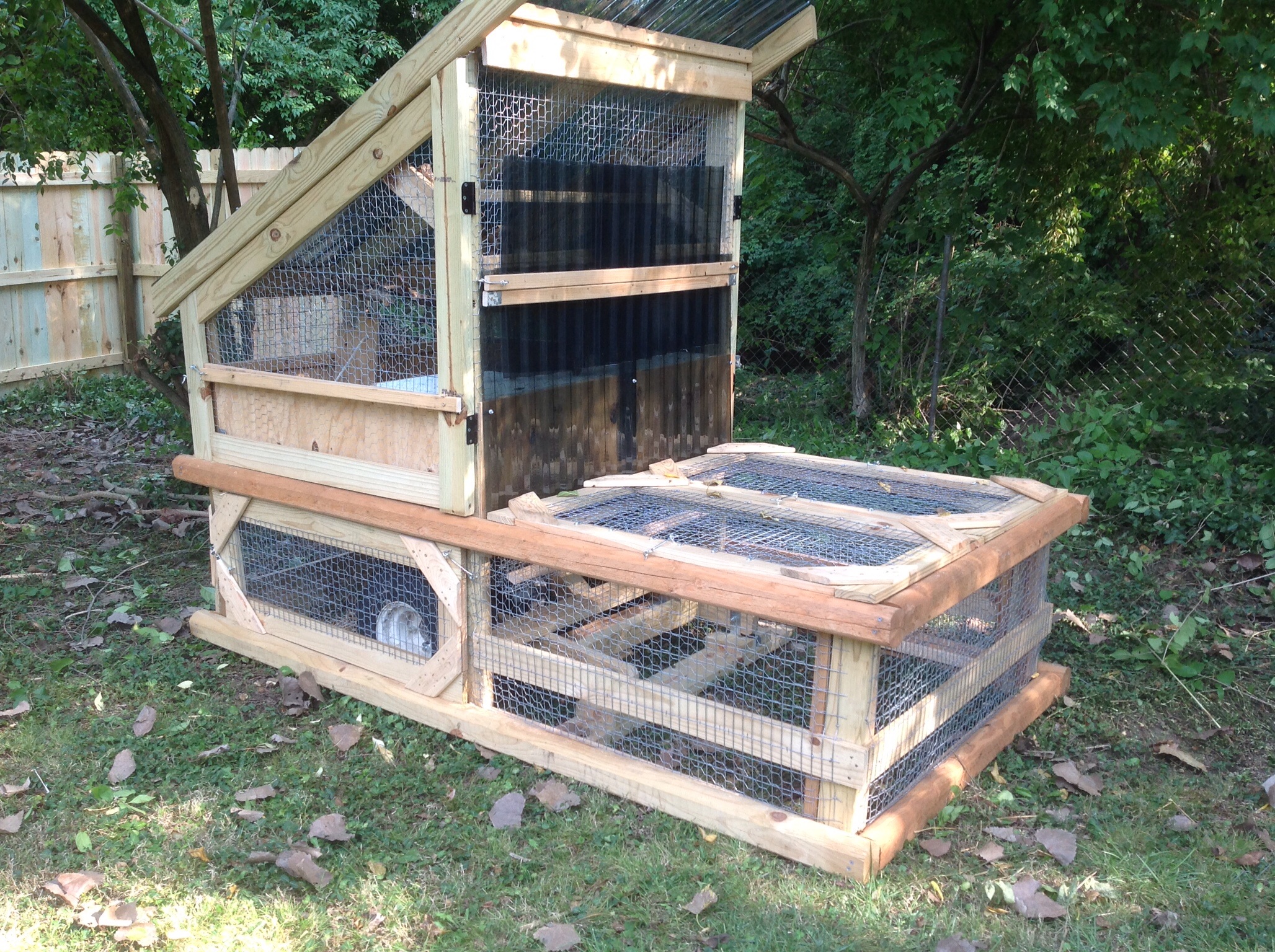 I designed this chicken tractor to blend with deck and patio sections in my yard.   It uses the rear axel and wheels from an EZ GO golf cart connected to the frame with a 6 part  line  to raise the frame about 8 inches off the ground to relocate the CT.
