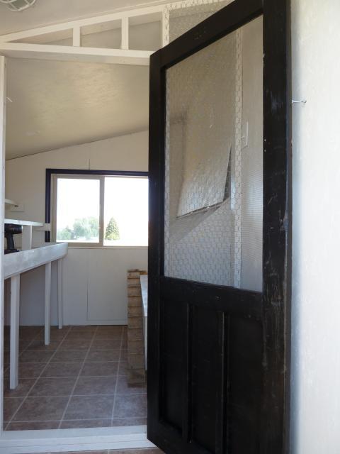 I had an old (antique) screen door that needed some repair and a new paint job to work, but it is wonderful and looks great!  That door has about 10 different colors under the black - I ended up spray painting it and it looks great!