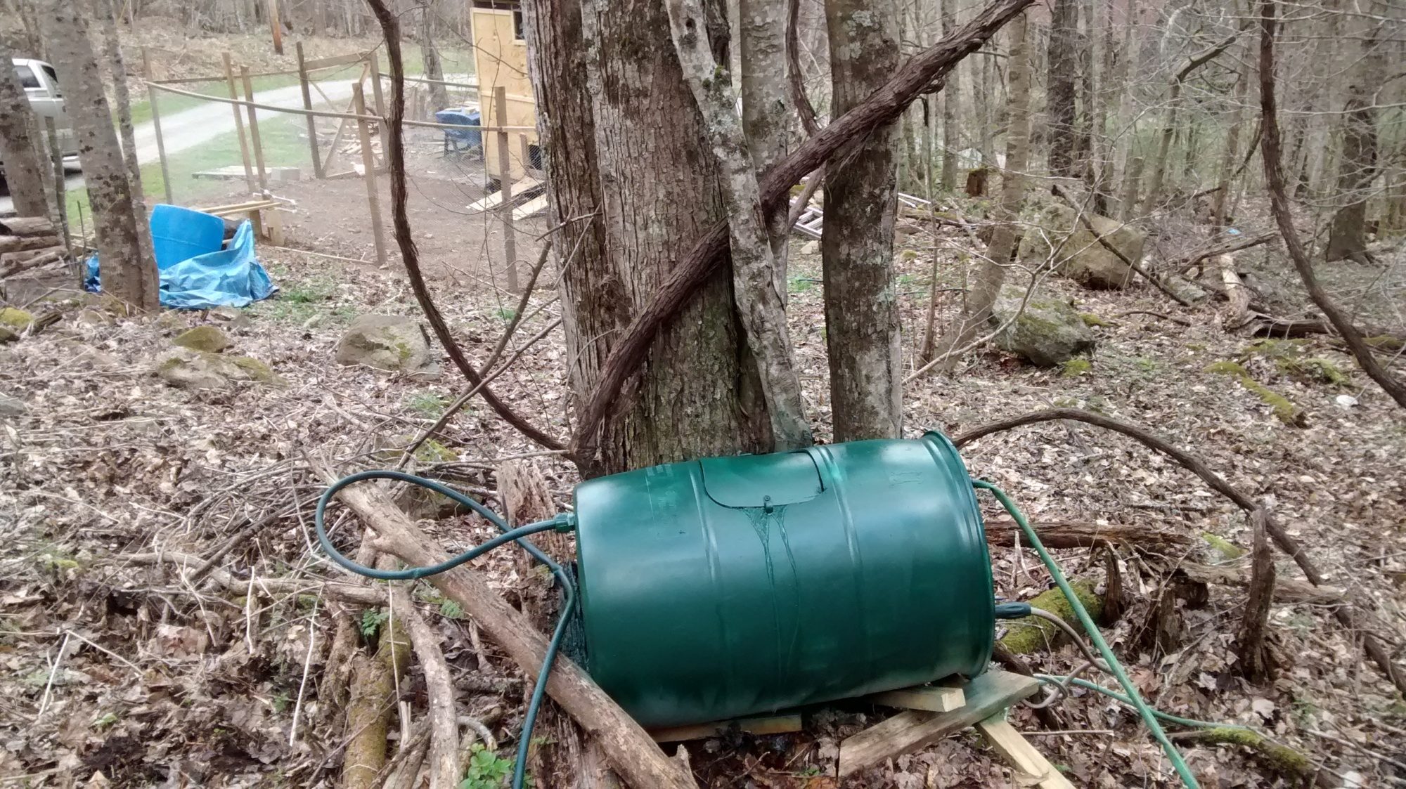 I have an elevated creek below on the right out of frame.  This my water barrel I feed from that creek and connected to water hose i now have water onsite at my chicken house.
