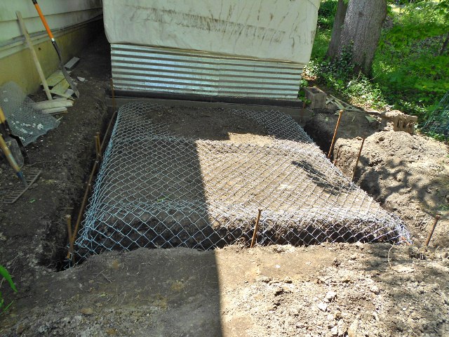 I'm concerned that buried hardware cloth will rust through in a couple of years; chain link fencing was on sale, about $45 or a 4' x 50' roll, 11.5 gauge. The raccoons won't dig through this!