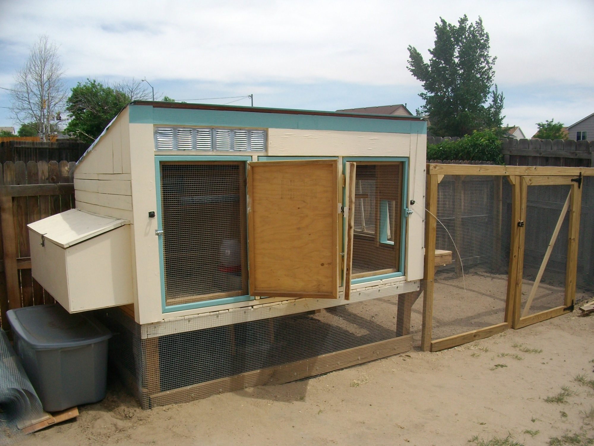 In full ventilation mode.  Two of the three main access doors opened and latched to each other.  The hardware cloth-covered doors under them can be opened as needed for access without having to close the open solid doors.  The coop is elevated 2' above ground on 4 by 4 posts and is 5'x8' with a 5'x12' run giving them 100 square feet of outside space to roam.  It stays nice and cool under the coop.