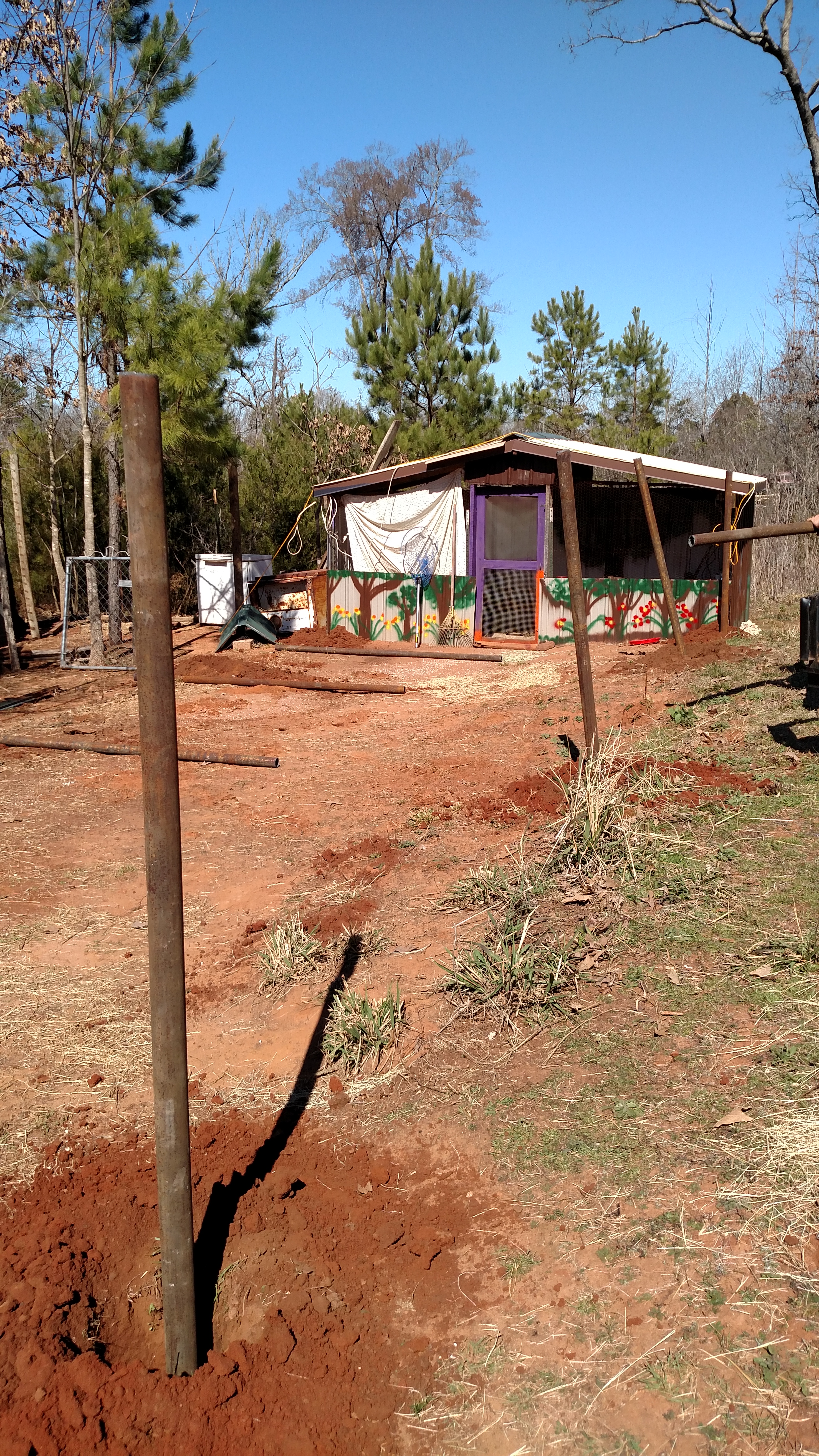 Initial progress report.  Holes dug, setting posts in concrete.