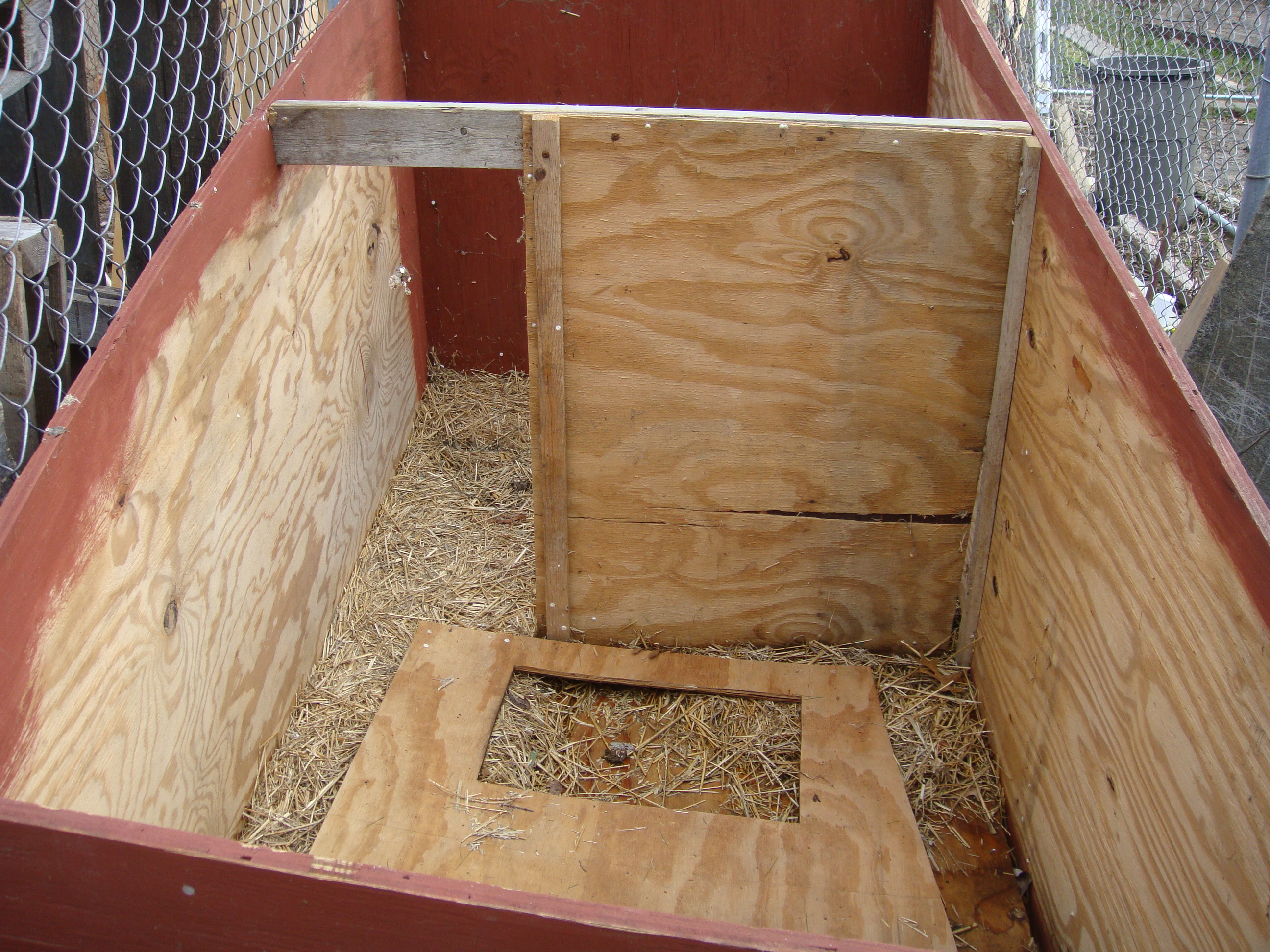 Inside dog house with center dividinf wall knocked on its side.