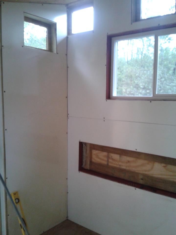 Inside front of coop, Walls up!  I used 4x8 sheets of bathroom board. I just thought to use this as it is already done and easy to wipe off!  AND no more painting :)