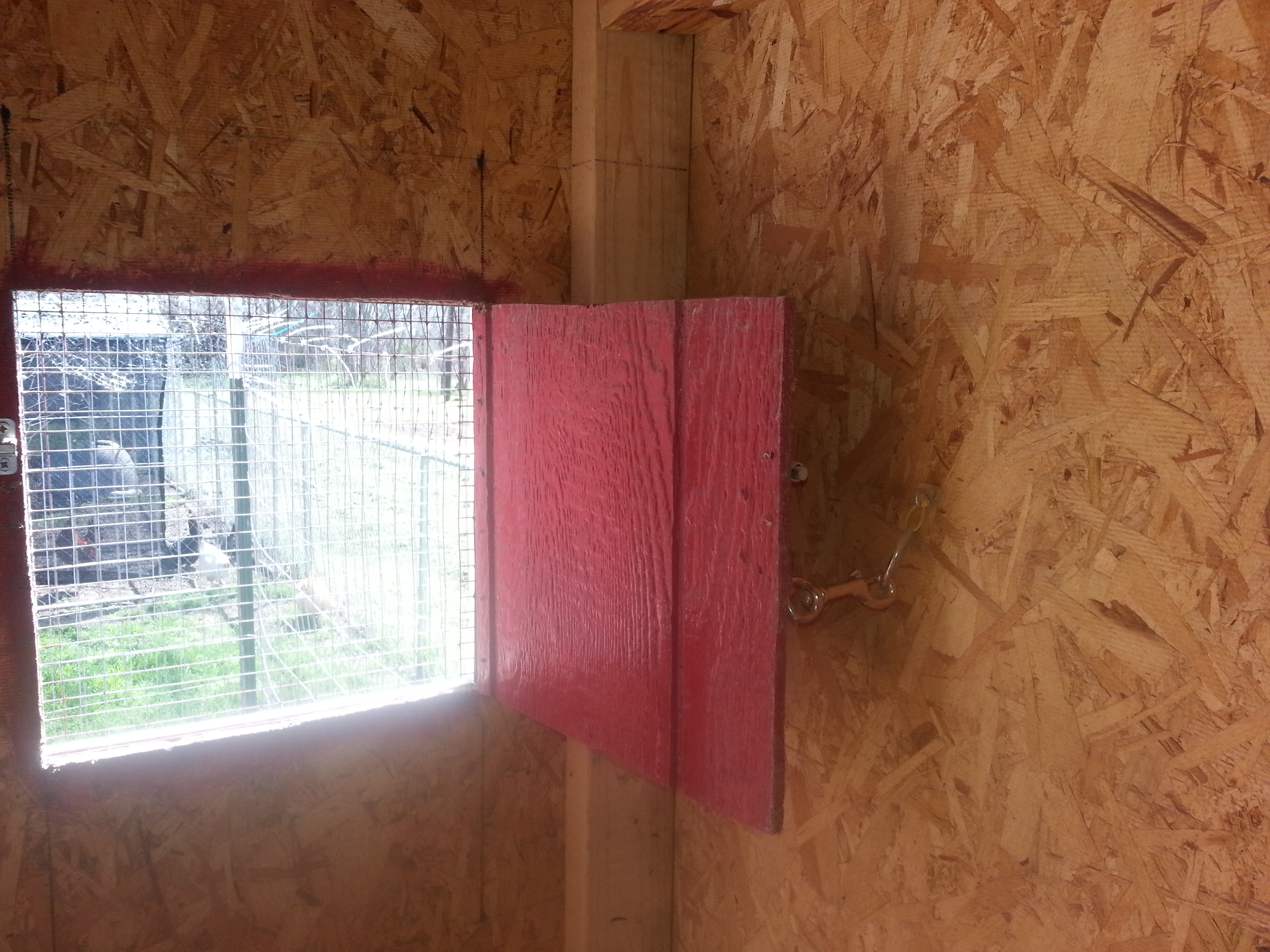 inside front window covered in hardware cloth with latch to keep open on windy days